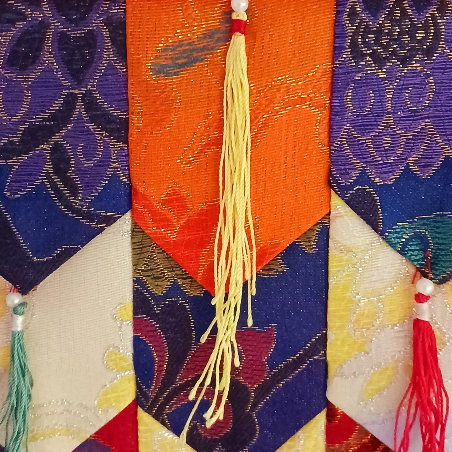 This Tibetan brocade Kaden Banner symbolizes the interlocking of the different Elements and directions.