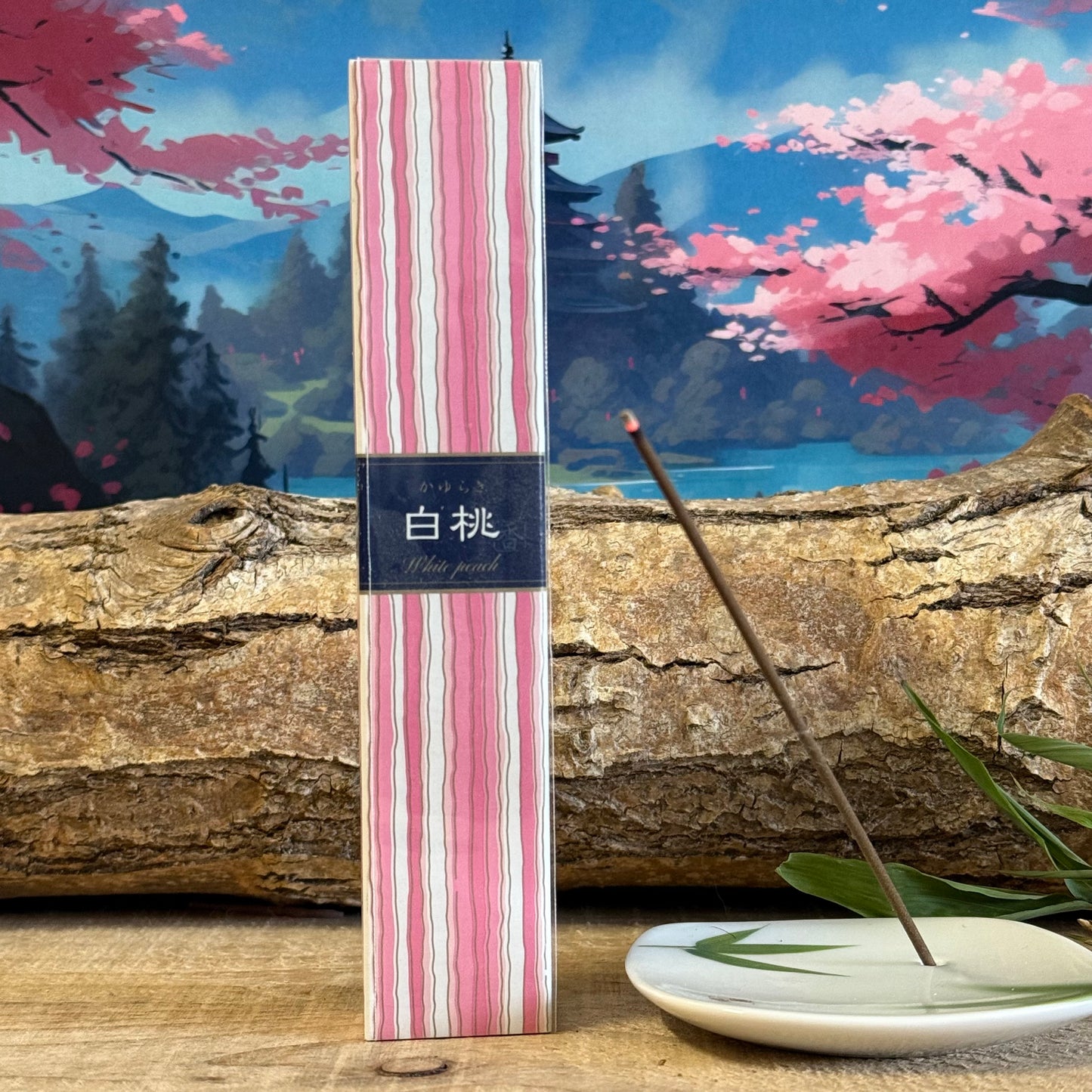 Kayuragi White Peach incense is a sweet and fruity scented incense product made in Japan by Nippon Kodo.
It’s part of the Kayuragi range of incense, which is renowned for being well made and of superior quality. The fragrance notes of the white peach incense are sweet, fresh and fruity and it’s an uplifting scent to enjoy.
The 40 incense sticks come with a small incense stick holder, so make an ideal gift. They come in a wooden Paulownia box, which is decorated with a striking pink and white stripe