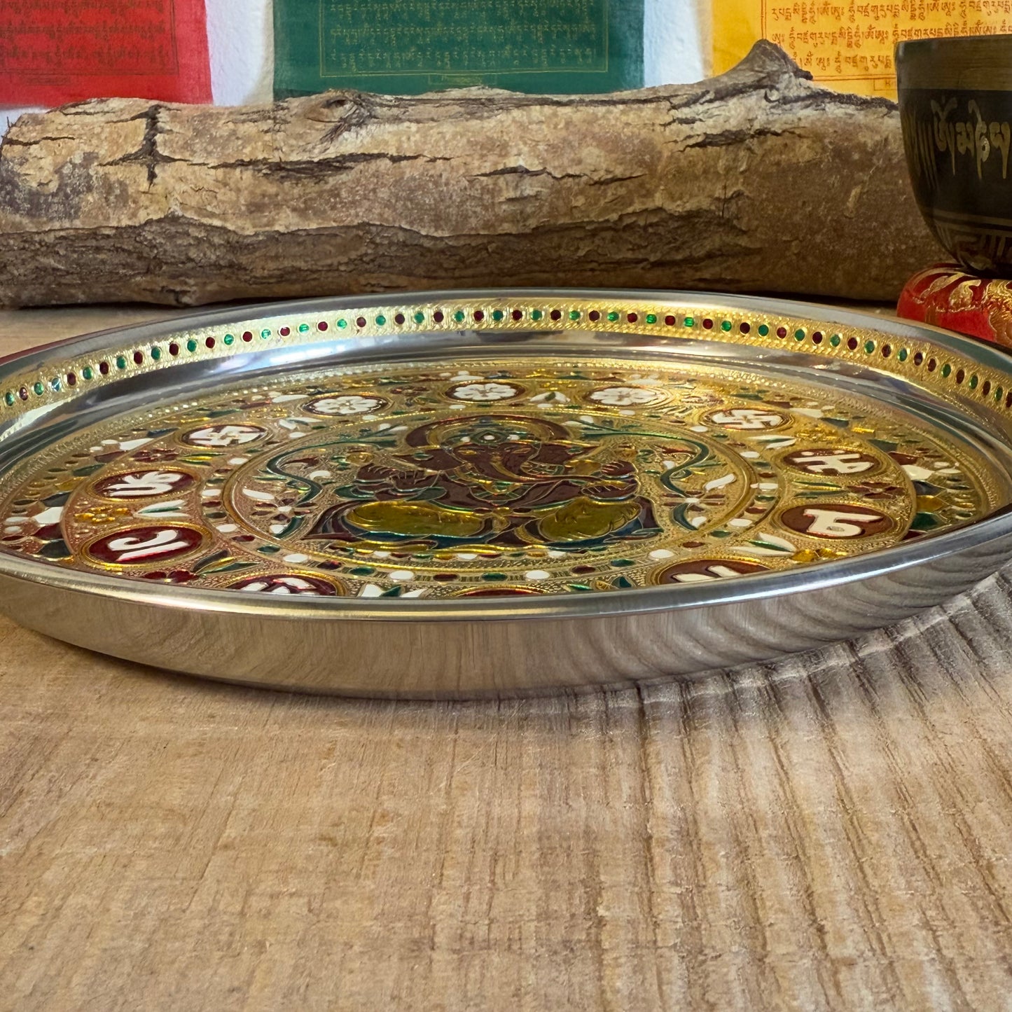 The Ganesh Offering Tray is a beautifully decorated Indian dish made from aluminum. It is traditionally used for offering items such as candles, incense, flowers, or food in ceremonies and rituals.
Key Features:
Material: Aluminum, with intricate Ganesh decorations.
Traditional Use: Perfect for placing offerings like flowers, food, candles, or incense.
Size: 28 cm diameter and 2.5 cm height.
Care Note: Not heat-resistant. Ensure to use a fireproof surface when burning candles or incense on the tray to prev