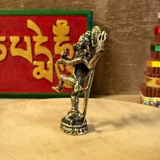 Celebrate the eternal rhythm of creation and renewal with the Mini Brass Dancing Shiva, a finely detailed brass sculpture depicting Lord Shiva in his sacred form as Nataraja, the Cosmic Dancer. Cast in radiant golden brass, this miniature statue captures Shiva’s graceful movement within the circle of flames—a symbol of the universe’s perpetual cycles of birth, preservation, and dissolution.