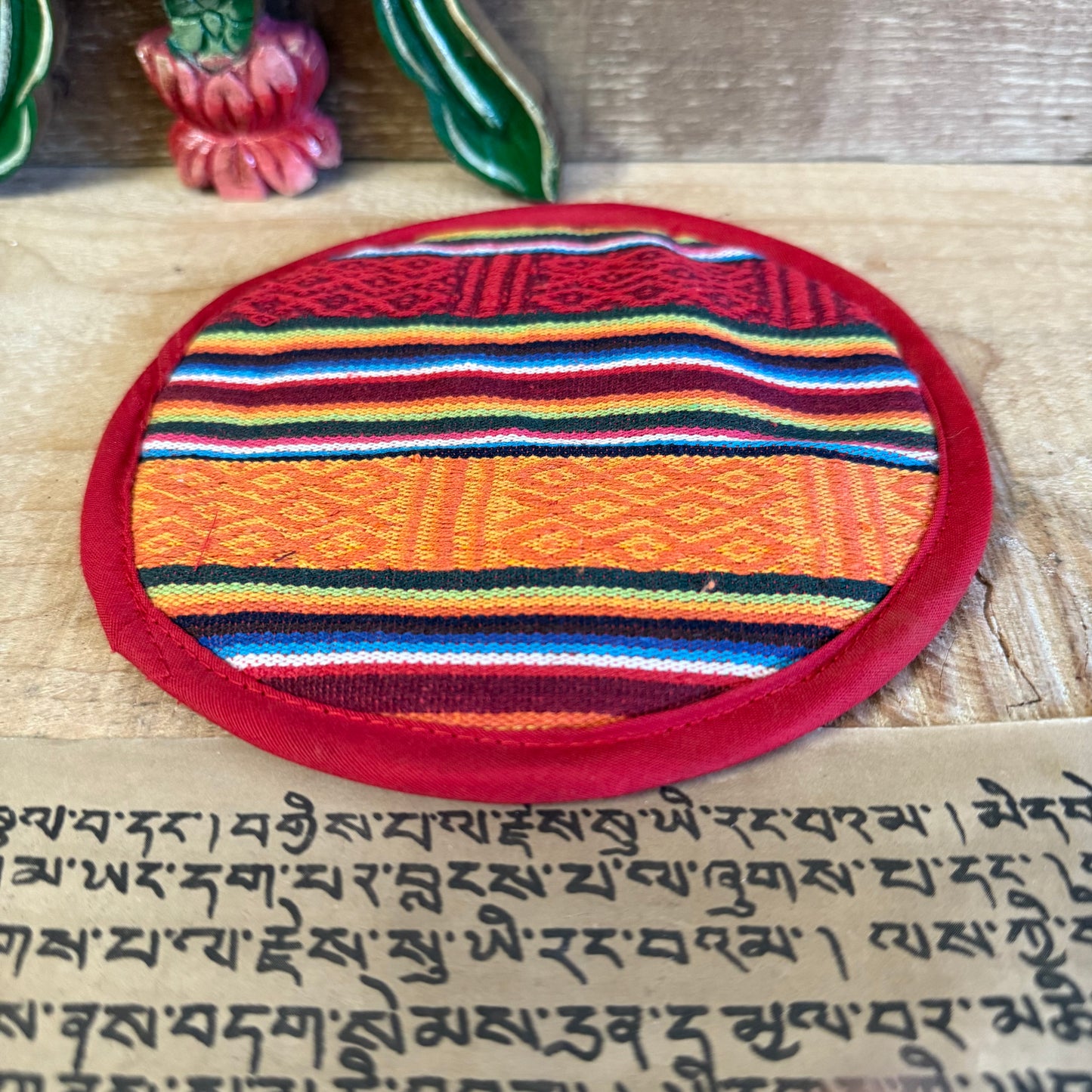 Even the singing bowl, when resting, deserves a place of dignity.
This 15cm round brocade cushion offers a soft yet stable resting place for your Tibetan singing bowl. Hand-stitched in Nepal from richly woven cotton, it helps protect your bowl while enhancing the clarity and resonance of its sacred sound.
Perfect for medium to larger-sized singing bowls, this cushion supports your practice—whether you use the bowl for meditation, sound healing, or daily mindfulness rituals. Crafted under Fair Trade princi