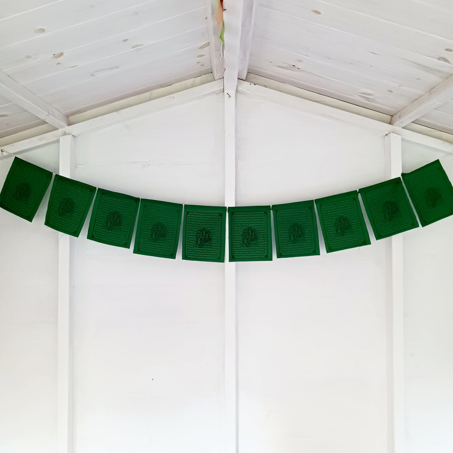 Invite the blessings of Green Tara, the Bodhisattva of Salvation, into your home or sacred space with this vibrant string of 10 prayer flags. Known for her swift and compassionate energy, Green Tara helps release fears, overcome challenges, achieve goals, and protect against negative influences.