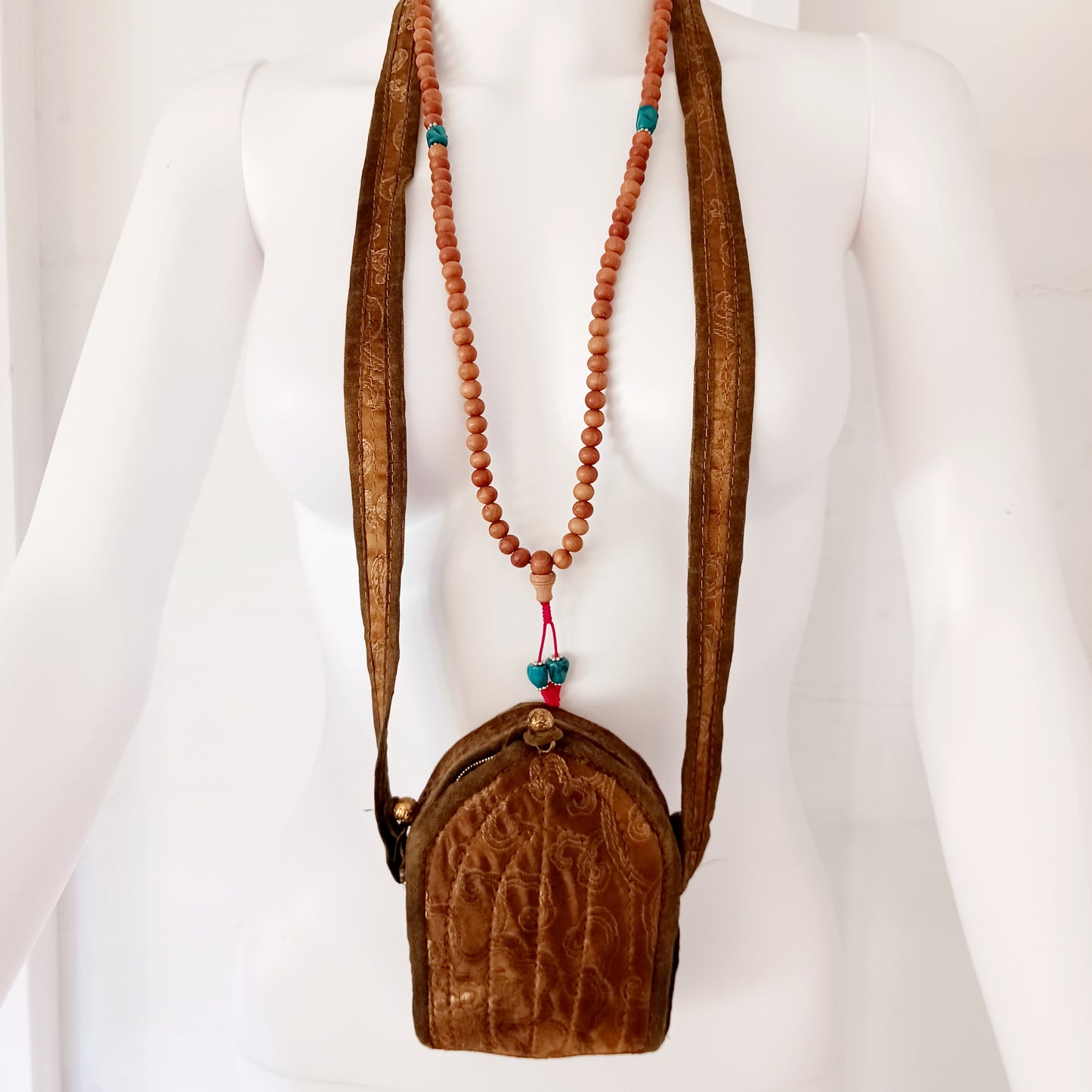 Discover the spiritual power of the Tibetan Ghau, a portable shrine and traditional prayer box used to carry sacred relics, charms, and medicinal herbs. Crafted by skilled Tibetan refugee artisans in Nepal, each Ghau serves as a portable shrine offering protection and blessings during travel. Wear it as a pendant around your neck or hang it from a waist sash or belt. This handcrafted piece is not only a spiritual talisman but also a beautiful work of art, connecting you to centuries-old Tibetan traditions.