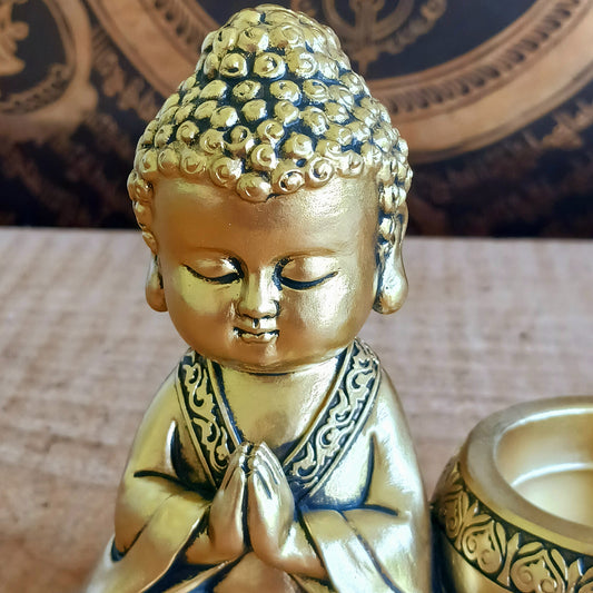 Bring a sense of peace and mindfulness into your home with this elegant Gold Buddha Tealight Candle Holder. Featuring a beautifully crafted praying Buddha figure alongside a tealight holder, this decorative piece creates a calming ambiance wherever it is placed.