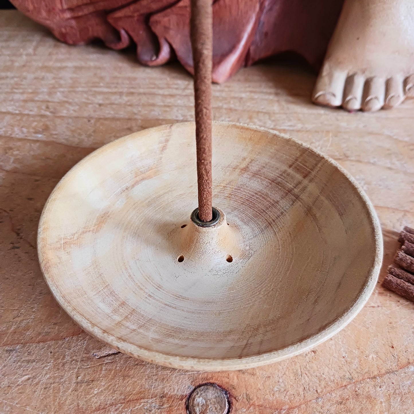 Bring a touch of Himalayan craftsmanship into your space with this beautifully hand-carved incense holder, crafted from a single piece of yellow wood sourced in Nepal. Each piece is skilfully shaped by local artisans, giving it its own natural character and charm.