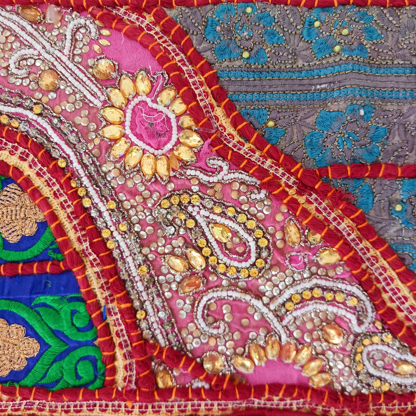 This long and beautifully intricate Indian Toran has been handmade from patches of vintage fabrics, wedding saris and recycled fabrics. It will be a unique addition to any home and bring vibrancy of colour and embellishment.