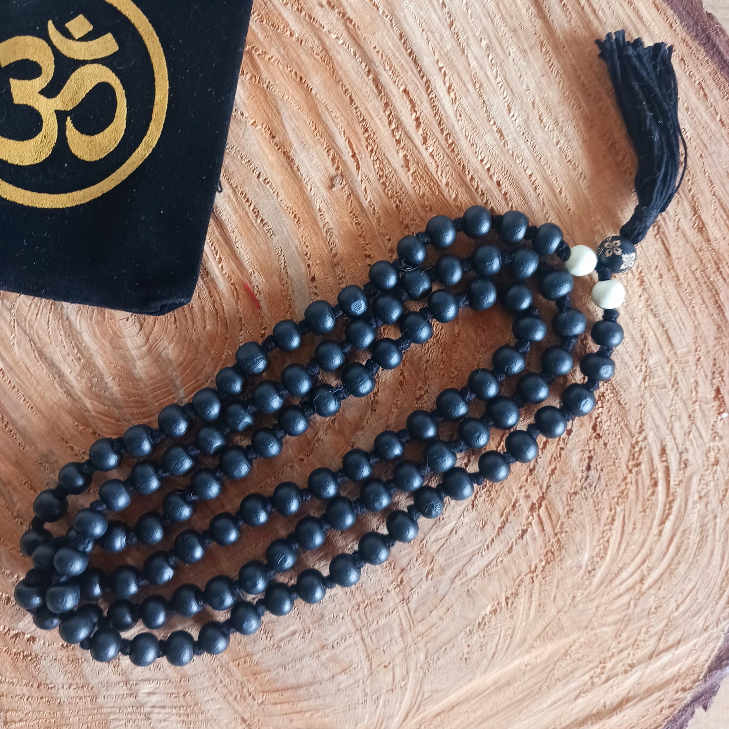 Handmade black wood Mala is idea for meditation. Each bead measures approximately 5-6mm, the mala measures approximately 55cm long.