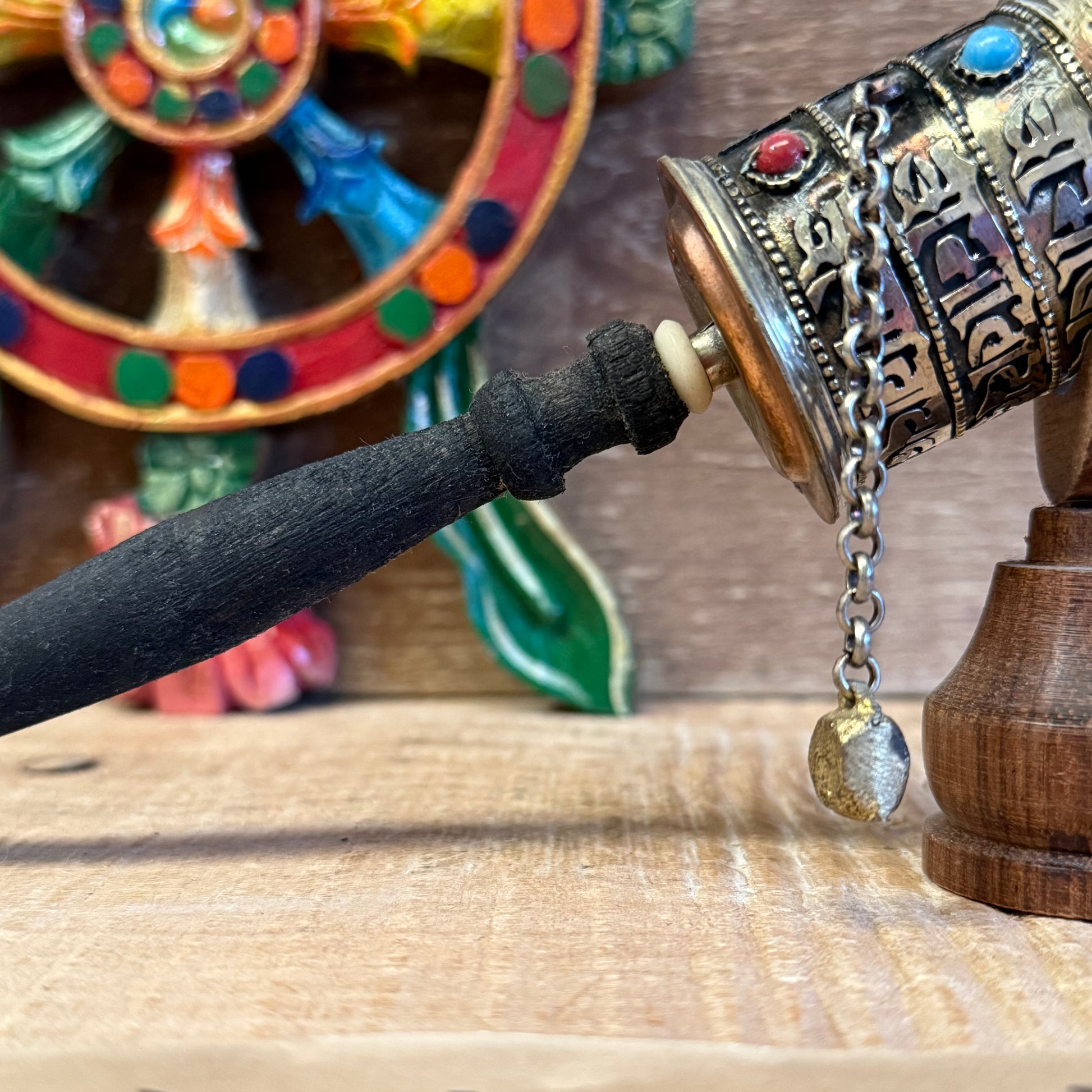 This sacred handheld prayer wheel carries the timeless mantra Om Mani Padme Hum, not just on its surface—but within its very core.

Measuring approximately 23cm in length, this traditional Buddhist Mani Wheel is crafted from metal and fitted with a smooth wooden handle. Inside the wheel, a sacred scroll contains thousands of repetitions of the mantra, empowering each rotation with the spiritual energy of compassion and wisdom.