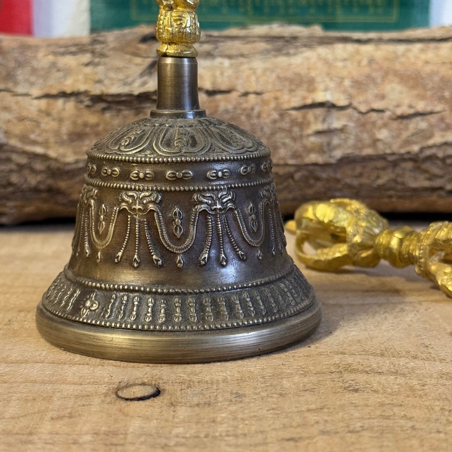 Discover the intricately engraved Kirtimukha Bell and Dorje Set, a primary ritual tool in Tibetan Buddhism. Handcrafted in Nepal, this bronze and brass set symbolizes wisdom and compassion, perfect for rituals and meditation.