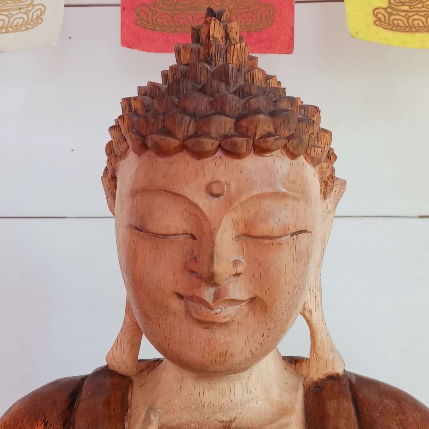 his beautifully serene Teaching Buddha statue has been carved by hand from Suar wood which is a fast-growing species, allowing for sustainable cultivation. The Albizia Saman species of tree is widespread, abundant, and in no danger of extinction. The Buddha is carved using tools in the traditional Balinese way, bringing each detail to life in a three-dimensional work of art. Hand carved Buddha statues can take up to weeks to carve.  The Buddha is in the Teaching Pose which signifies wisdom, understanding an