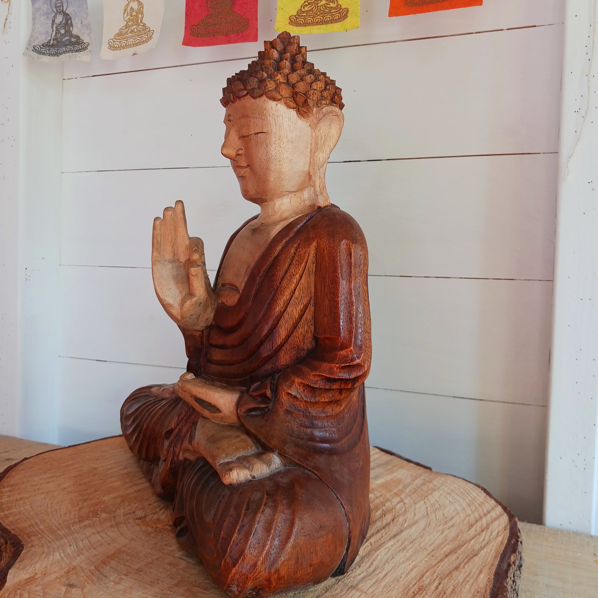 his beautifully serene Teaching Buddha statue has been carved by hand from Suar wood which is a fast-growing species, allowing for sustainable cultivation. The Albizia Saman species of tree is widespread, abundant, and in no danger of extinction. The Buddha is carved using tools in the traditional Balinese way, bringing each detail to life in a three-dimensional work of art. Hand carved Buddha statues can take up to weeks to carve.  The Buddha is in the Teaching Pose which signifies wisdom, understanding an