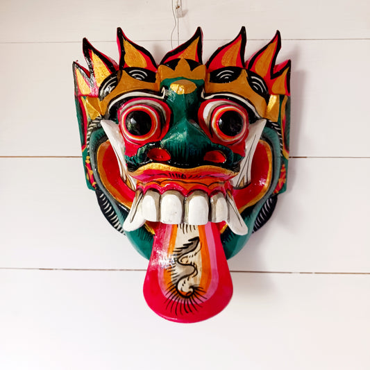 The Rangda mask is a traditional Balinese mask seen in the Barong dance. The mask depicts Rangda who is the queen of witches and represents the personification of all evil. She is depicted with a grosteque visage with protuding fangs, wild goggle eyes and long tongue. In the dance, she leads a terrifying army of witches against the forces of good and their leader, Barong.