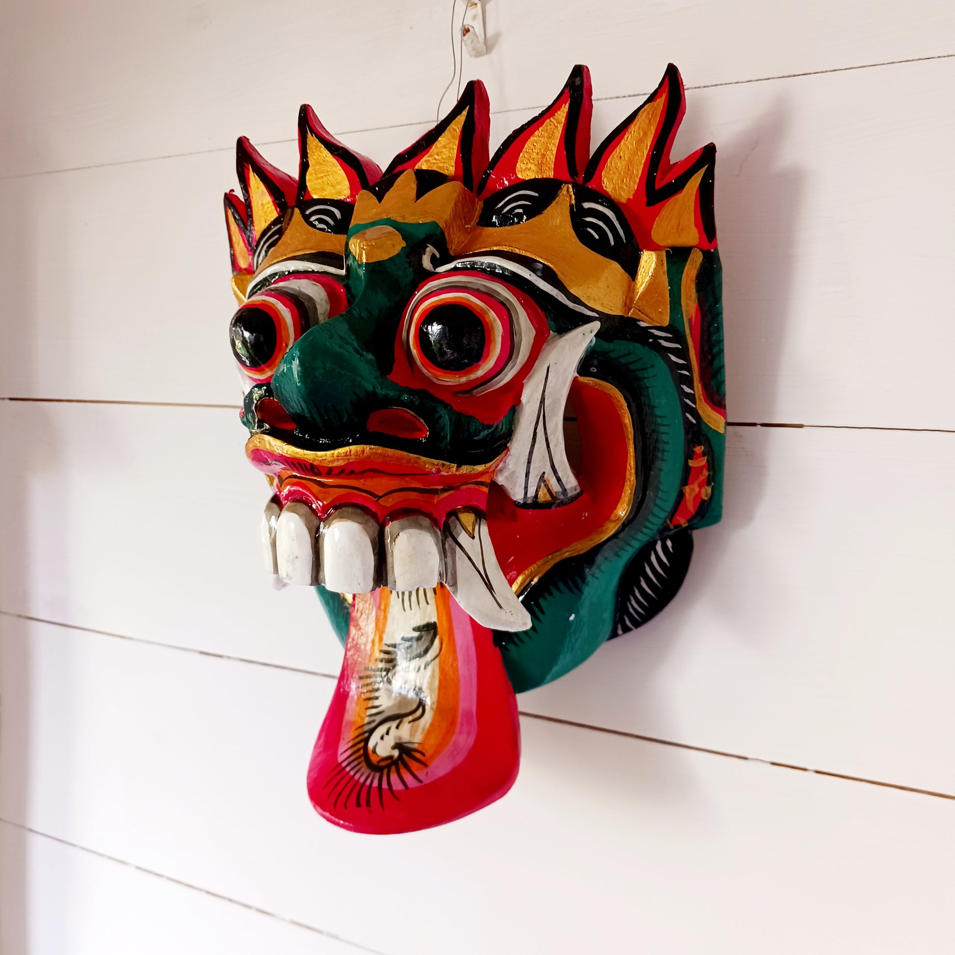 The Rangda mask is a traditional Balinese mask seen in the Barong dance. The mask depicts Rangda who is the queen of witches and represents the personification of all evil. She is depicted with a grosteque visage with protuding fangs, wild goggle eyes and long tongue. In the dance, she leads a terrifying army of witches against the forces of good and their leader, Barong.