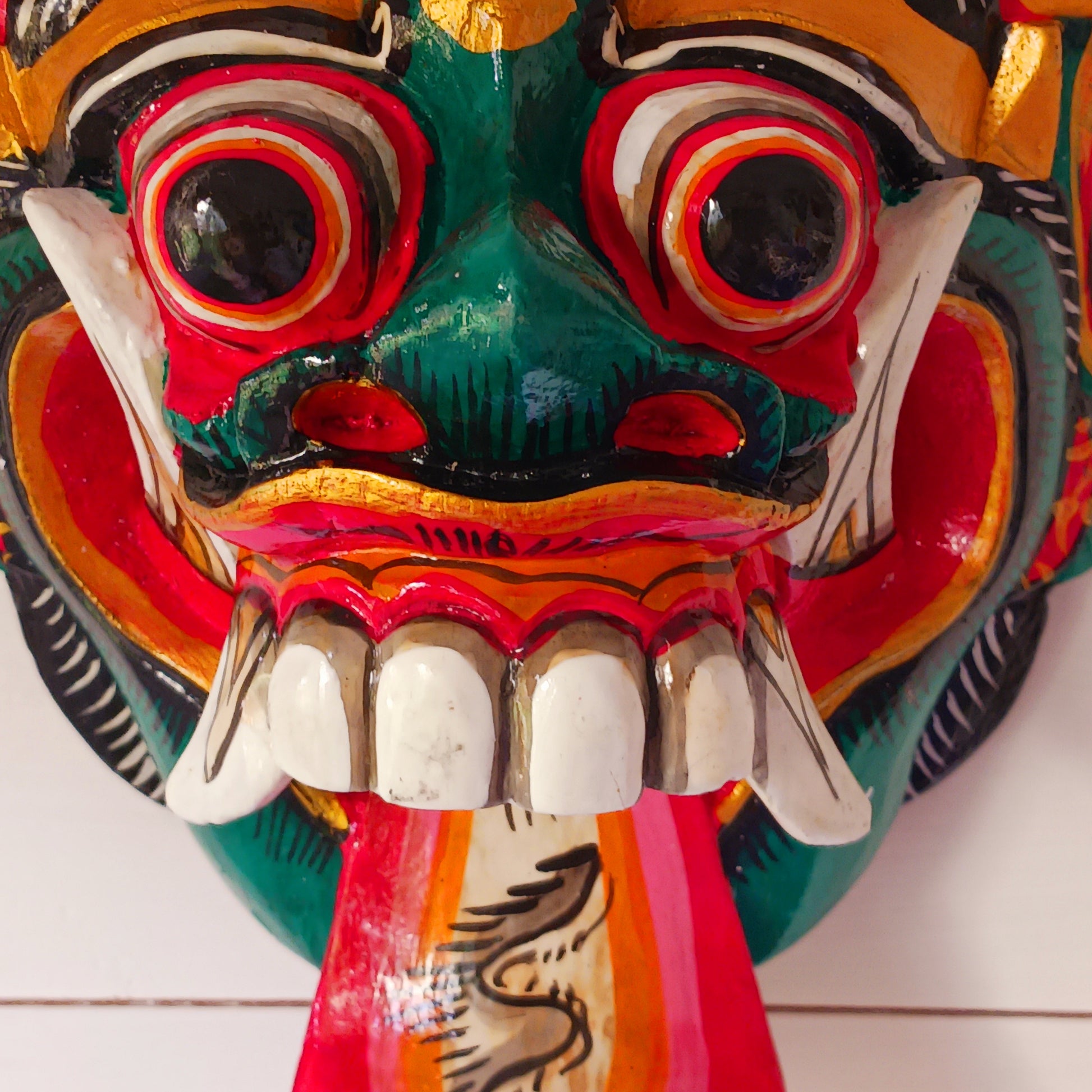 The Rangda mask is a traditional Balinese mask seen in the Barong dance. The mask depicts Rangda who is the queen of witches and represents the personification of all evil. She is depicted with a grosteque visage with protuding fangs, wild goggle eyes and long tongue. In the dance, she leads a terrifying army of witches against the forces of good and their leader, Barong.