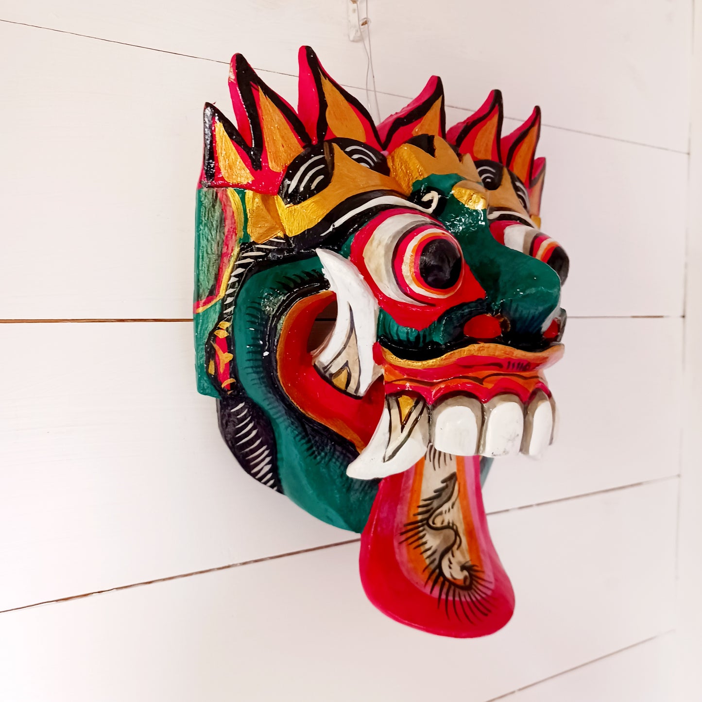 The Rangda mask is a traditional Balinese mask seen in the Barong dance. The mask depicts Rangda who is the queen of witches and represents the personification of all evil. She is depicted with a grosteque visage with protuding fangs, wild goggle eyes and long tongue. In the dance, she leads a terrifying army of witches against the forces of good and their leader, Barong.