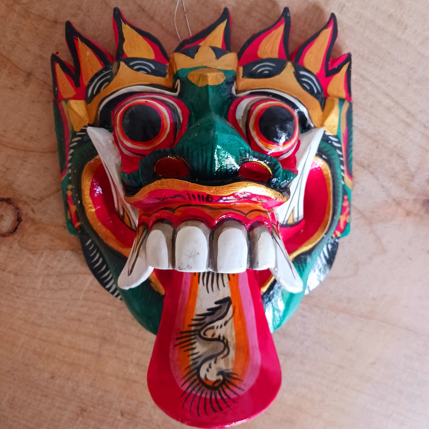 The Rangda mask is a traditional Balinese mask seen in the Barong dance. The mask depicts Rangda who is the queen of witches and represents the personification of all evil. She is depicted with a grosteque visage with protuding fangs, wild goggle eyes and long tongue. In the dance, she leads a terrifying army of witches against the forces of good and their leader, Barong.