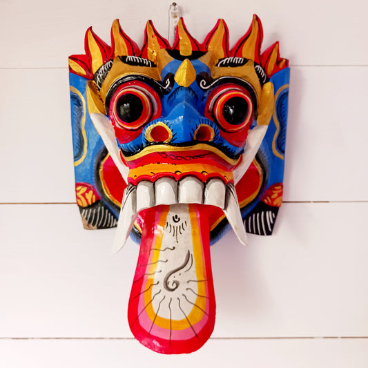 The Rangda mask is a traditional Balinese mask seen in the Barong dance. The mask depicts Rangda who is the queen of witches and represents the personification of all evil. She is depicted with a grotesque visage with protruding fangs, wild goggle eyes and long tongue. In the dance, she leads a terrifying army of witches against the forces of good and their leader, Barong.