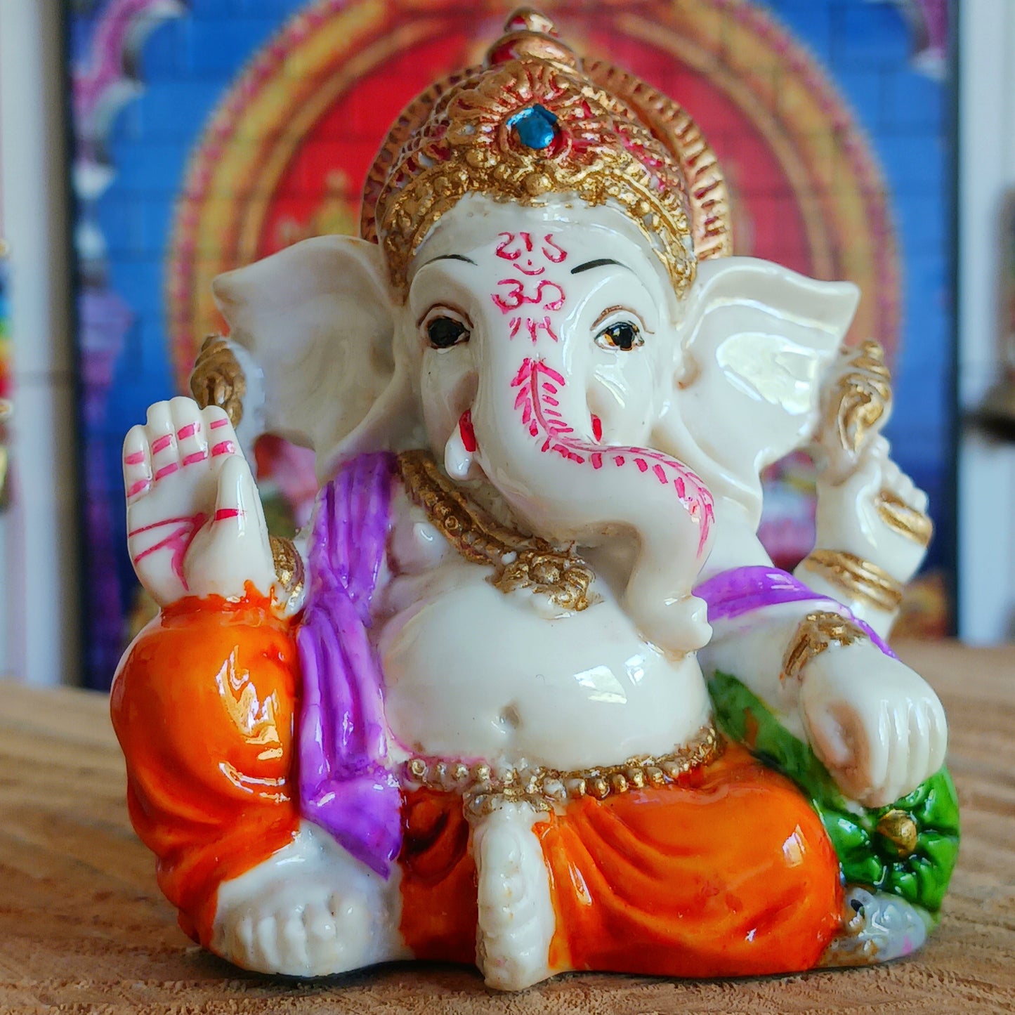 This delightful Ganesha statue is made of resin.&nbsp; In his upper left arm, this Ganesha holds a stick (ankusha), which is used to remove obstacles and guide the devotee's direction. In his upper right arm, he holds a noose (pasha), which symbolizes the power to control desire.