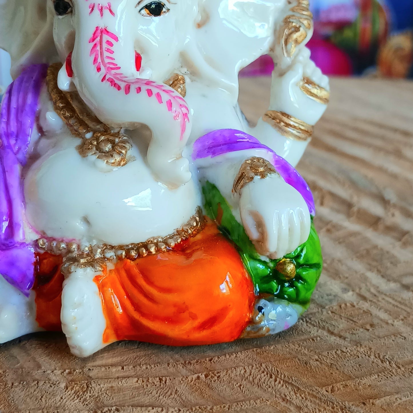 This delightful Ganesha statue is made of resin.&nbsp; In his upper left arm, this Ganesha holds a stick (ankusha), which is used to remove obstacles and guide the devotee's direction. In his upper right arm, he holds a noose (pasha), which symbolizes the power to control desire.