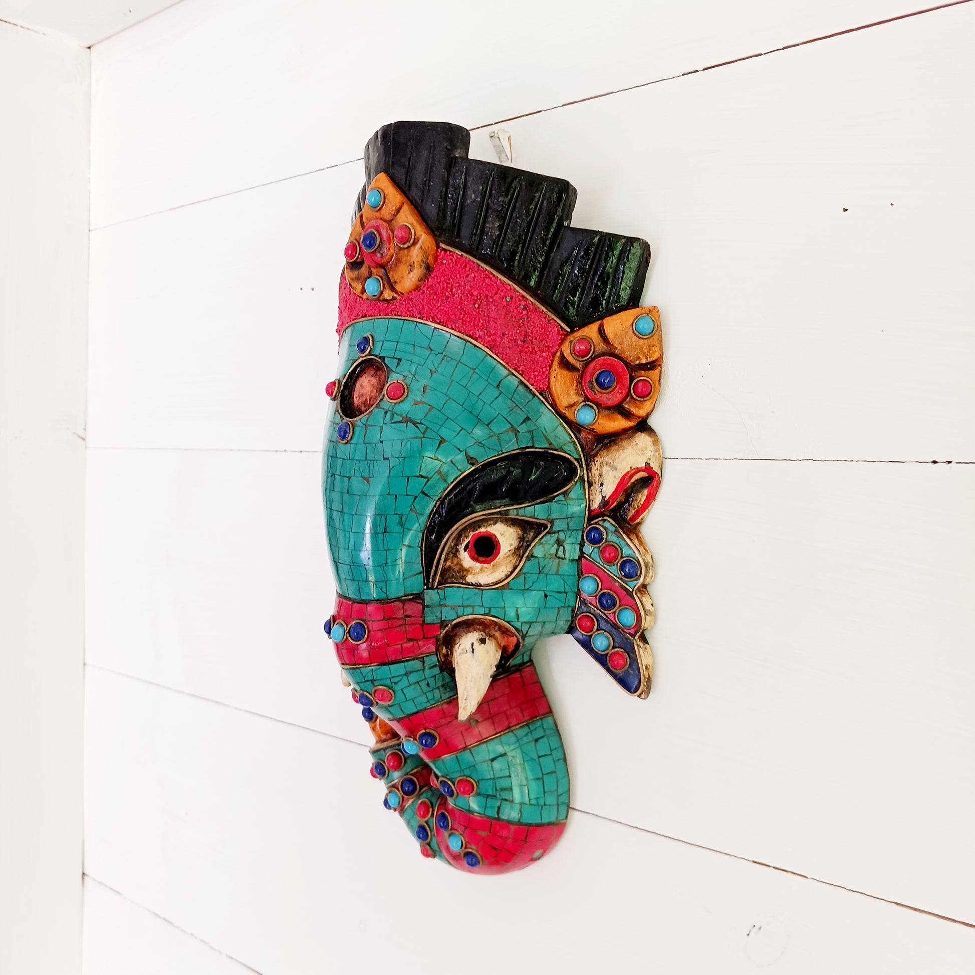 This stunning, handcrafted Lord Ganesh wooden mask is inlaid with Turquoise, Corals and Lapis.