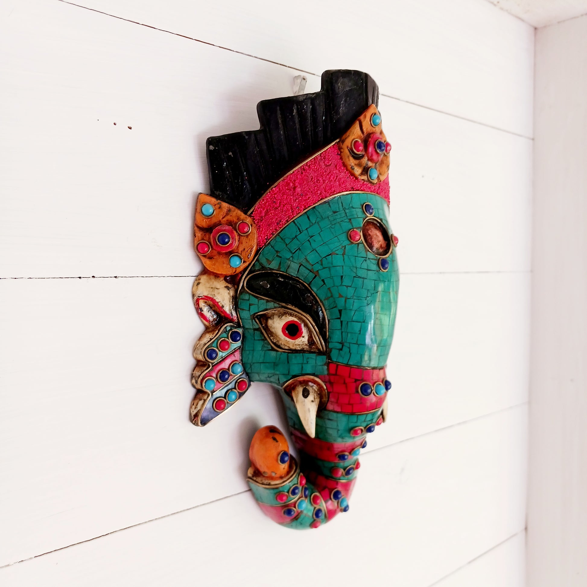 This stunning, handcrafted Lord Ganesh wooden mask is inlaid with Turquoise, Corals and Lapis.