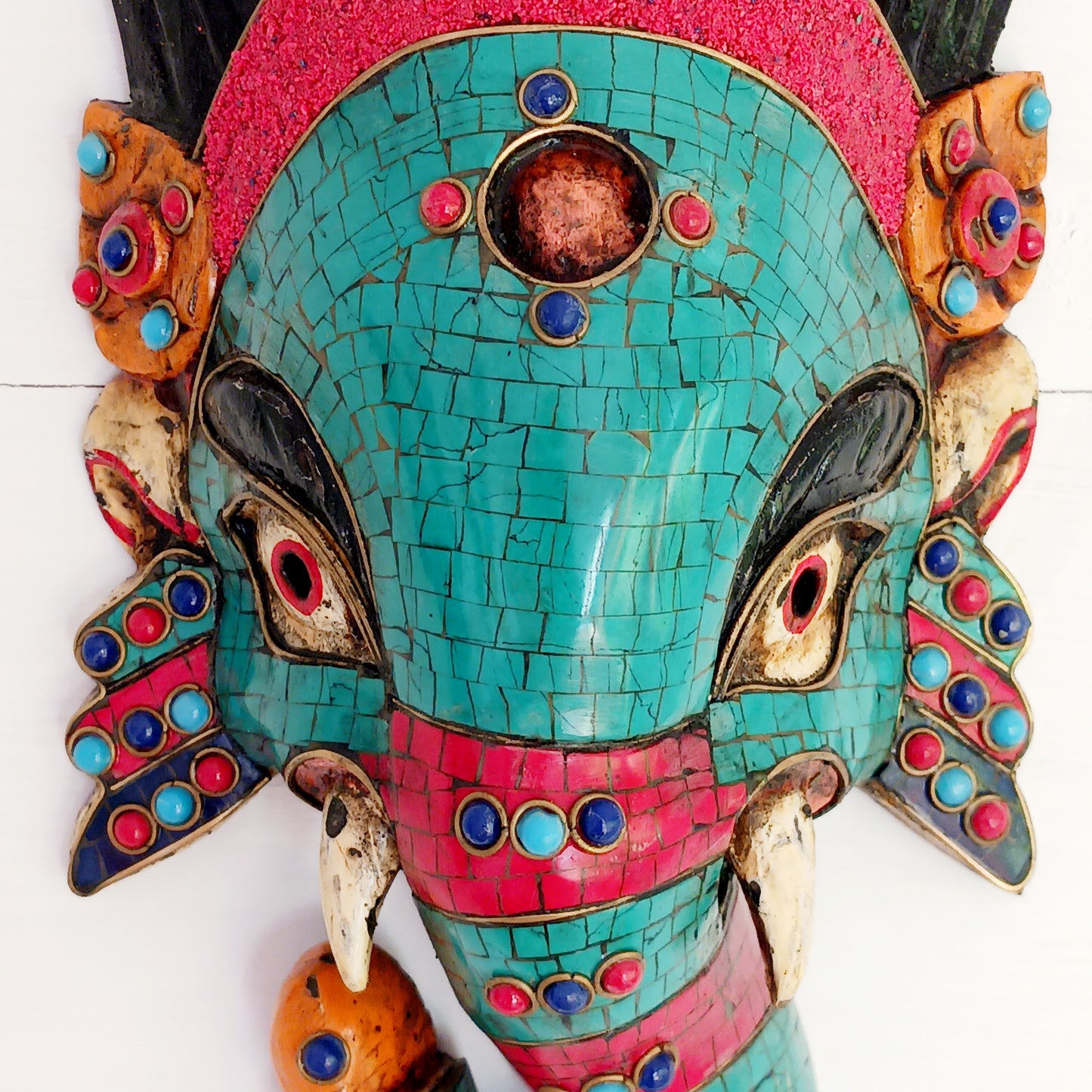 This stunning, handcrafted Lord Ganesh wooden mask is inlaid with Turquoise, Corals and Lapis.