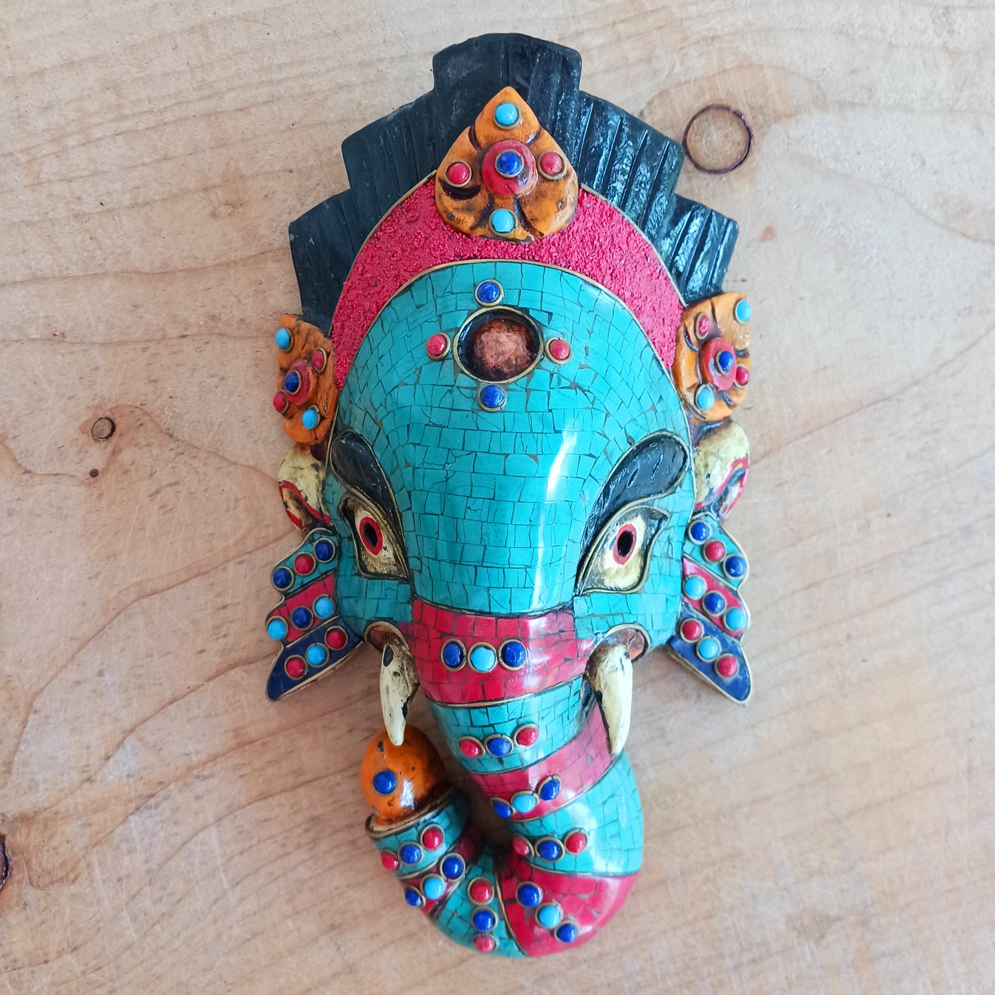 This stunning, handcrafted Lord Ganesh wooden mask is inlaid with Turquoise, Corals and Lapis.