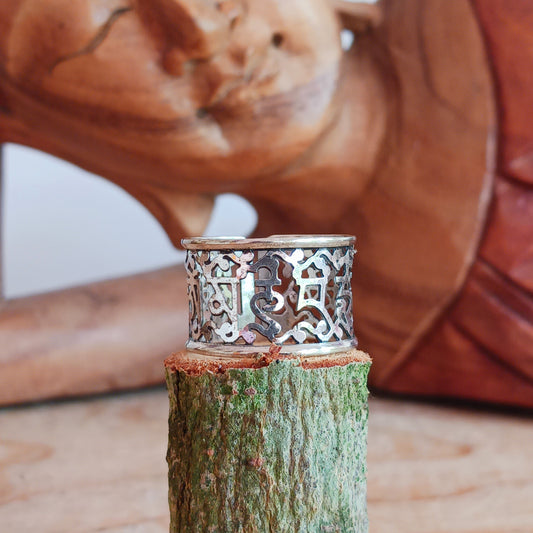 This Tibetan white metal cut out ring features the Tibetan Buddhist Prayer characters beautifully cut out from the band.