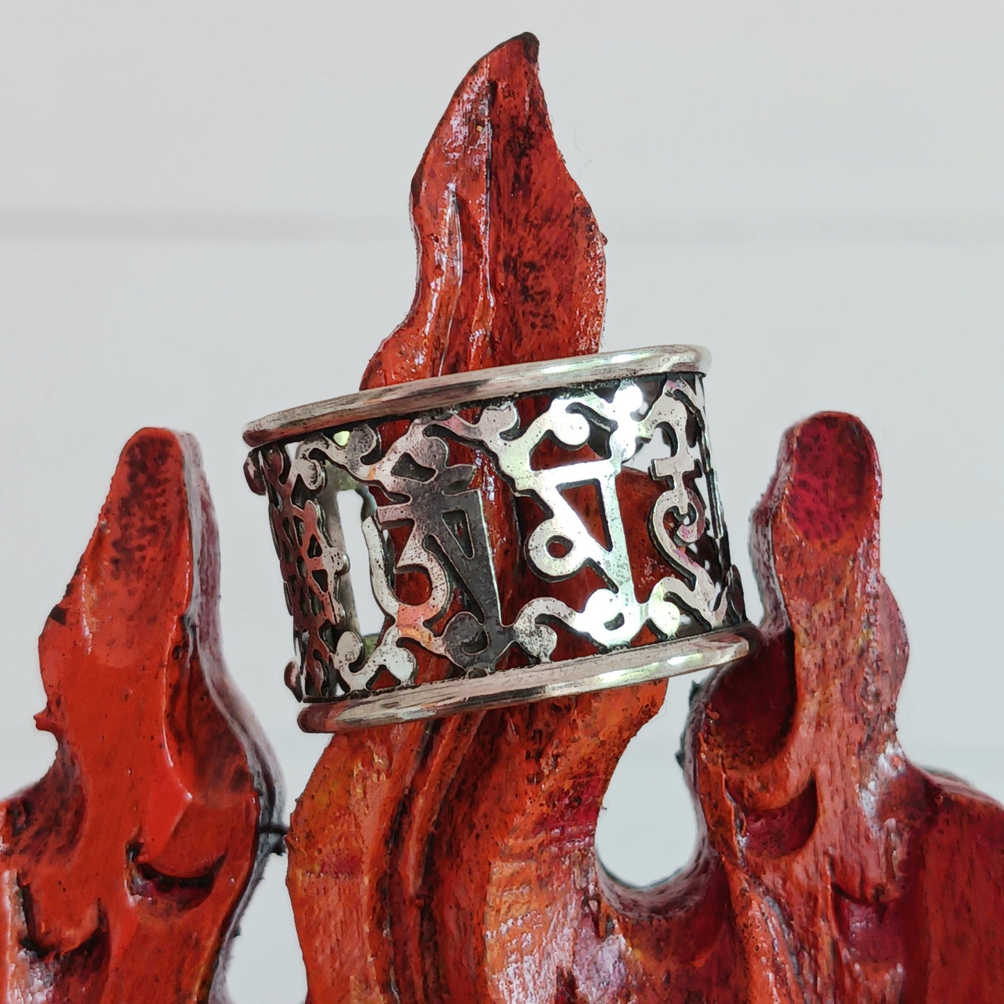 This Tibetan white metal cut out ring features the Tibetan Buddhist Prayer characters beautifully cut out from the band.