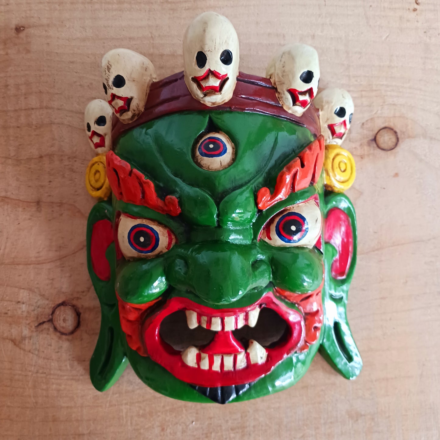 his Mahakala mask is a beautifully handcrafted wooden piece featuring intricate details and a unique design. Inspired by the powerful deity, this mask is a representation of strength, protection, and courage.