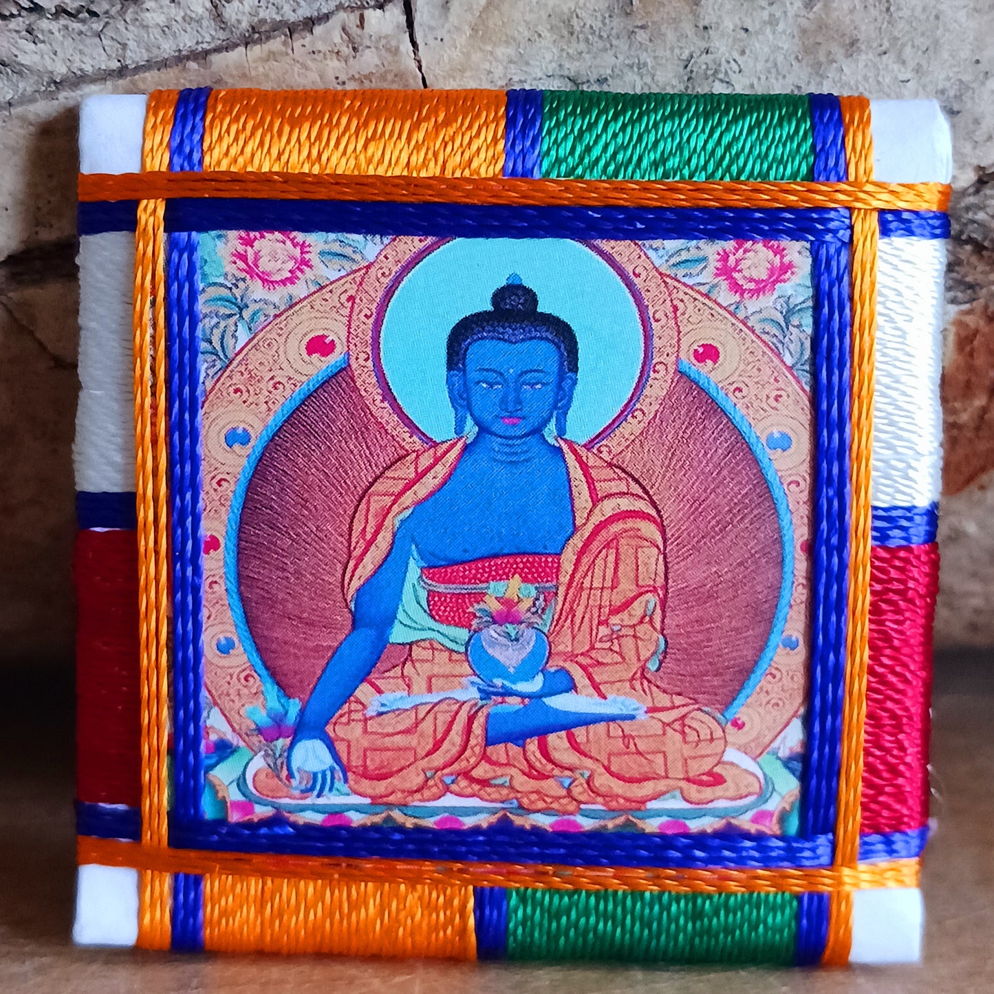 The healing embrace of the Medicine Buddha Protection Amulet, a sacred creation handmade in Nepal.