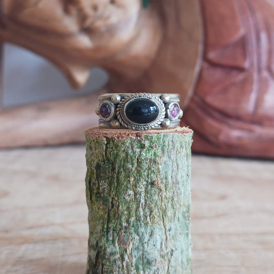 Nepalese white metal finger ring decorated with a black tourmaline centre stone and two tiny red coral stones either side.