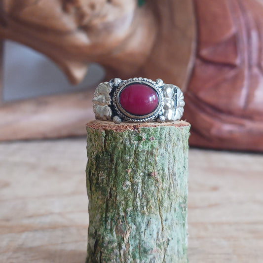 Nepalese white metal finger ring decorated with a red coral stone.