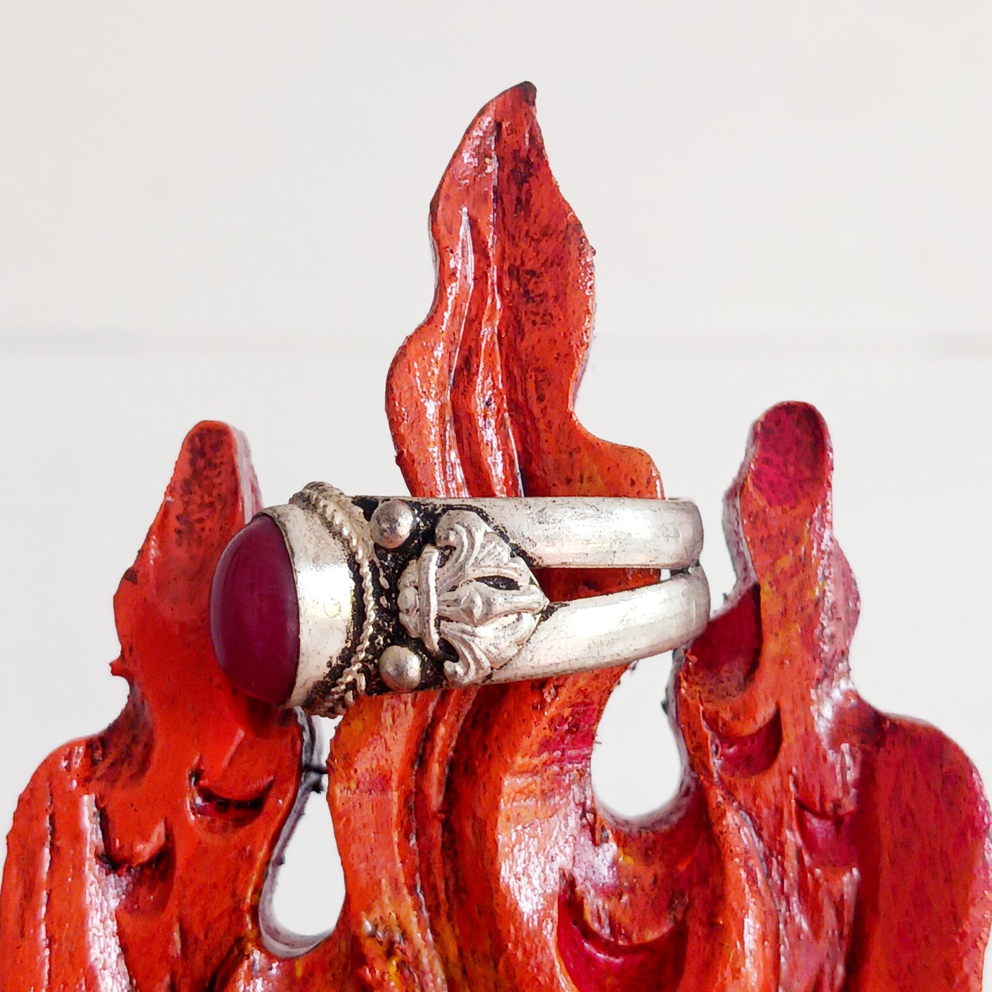 Nepalese white metal finger ring decorated with a red coral stone.