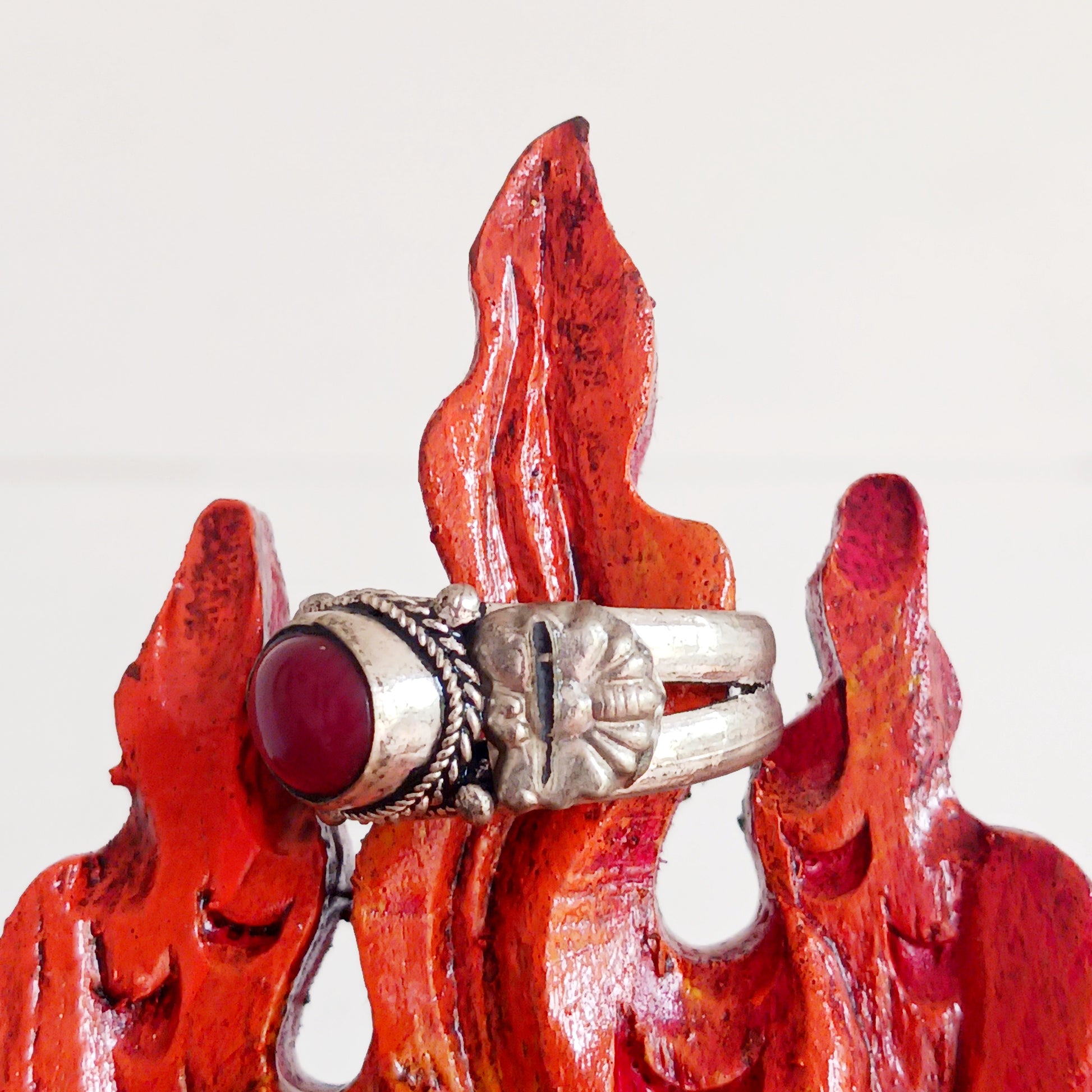 Nepalese white metal finger ring decorated with a red coral stone.