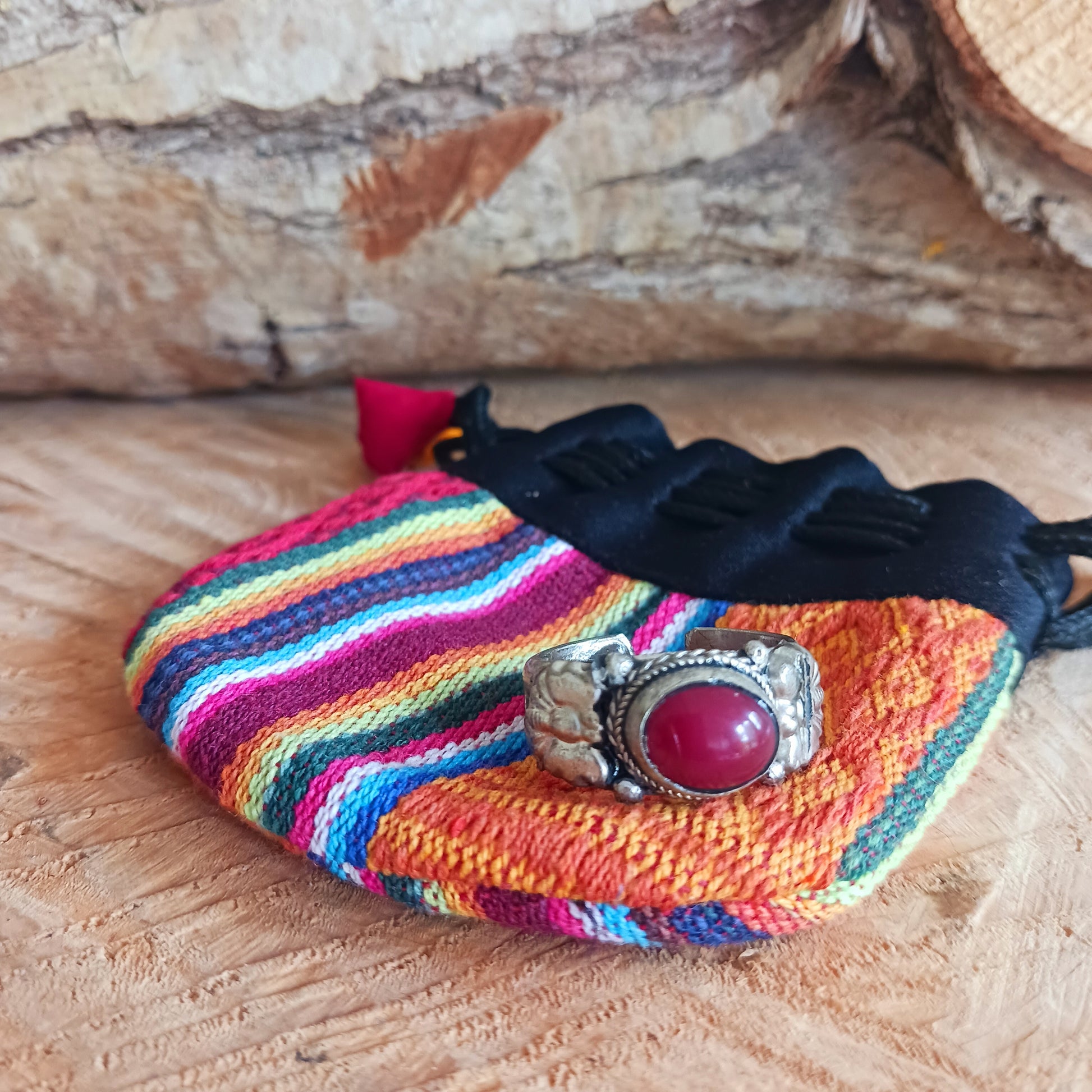 Nepalese white metal finger ring decorated with a red coral stone.