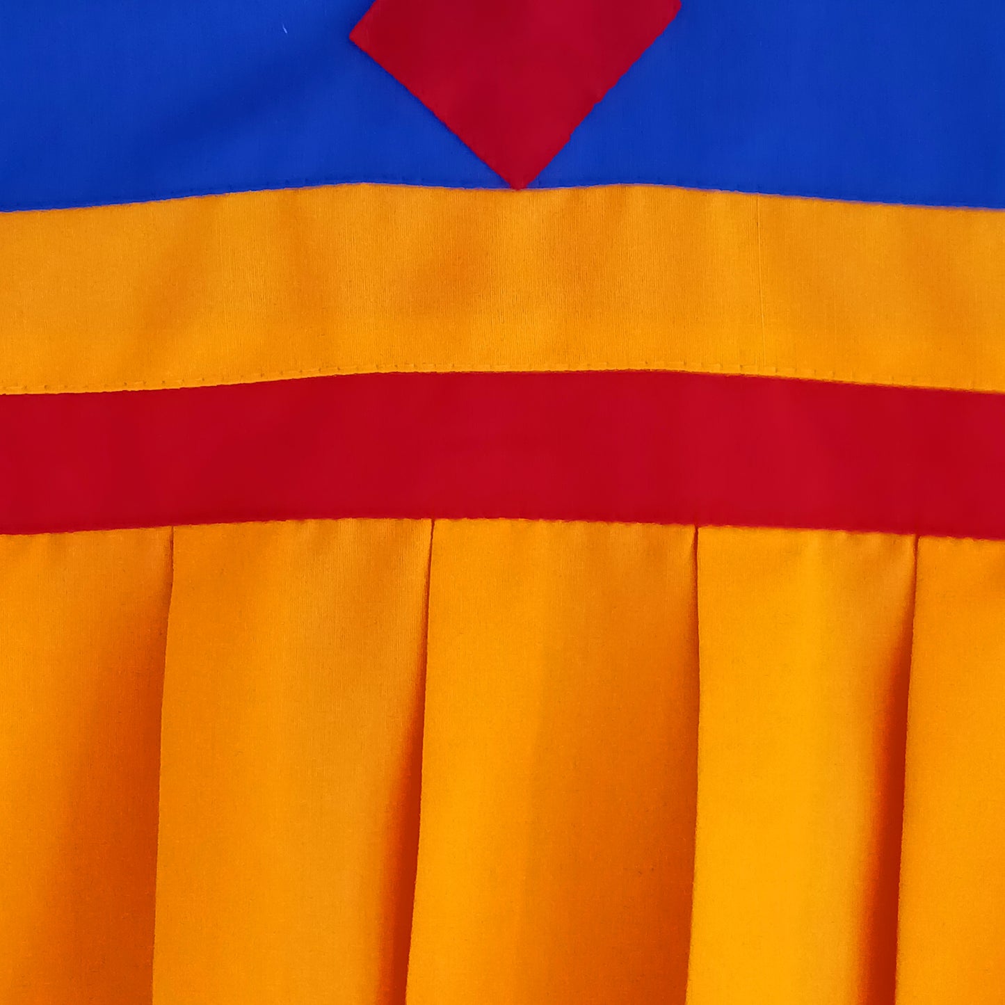 A fine quality traditional Tibetan door curtain displaying a hand embroidered Kalachakra. 