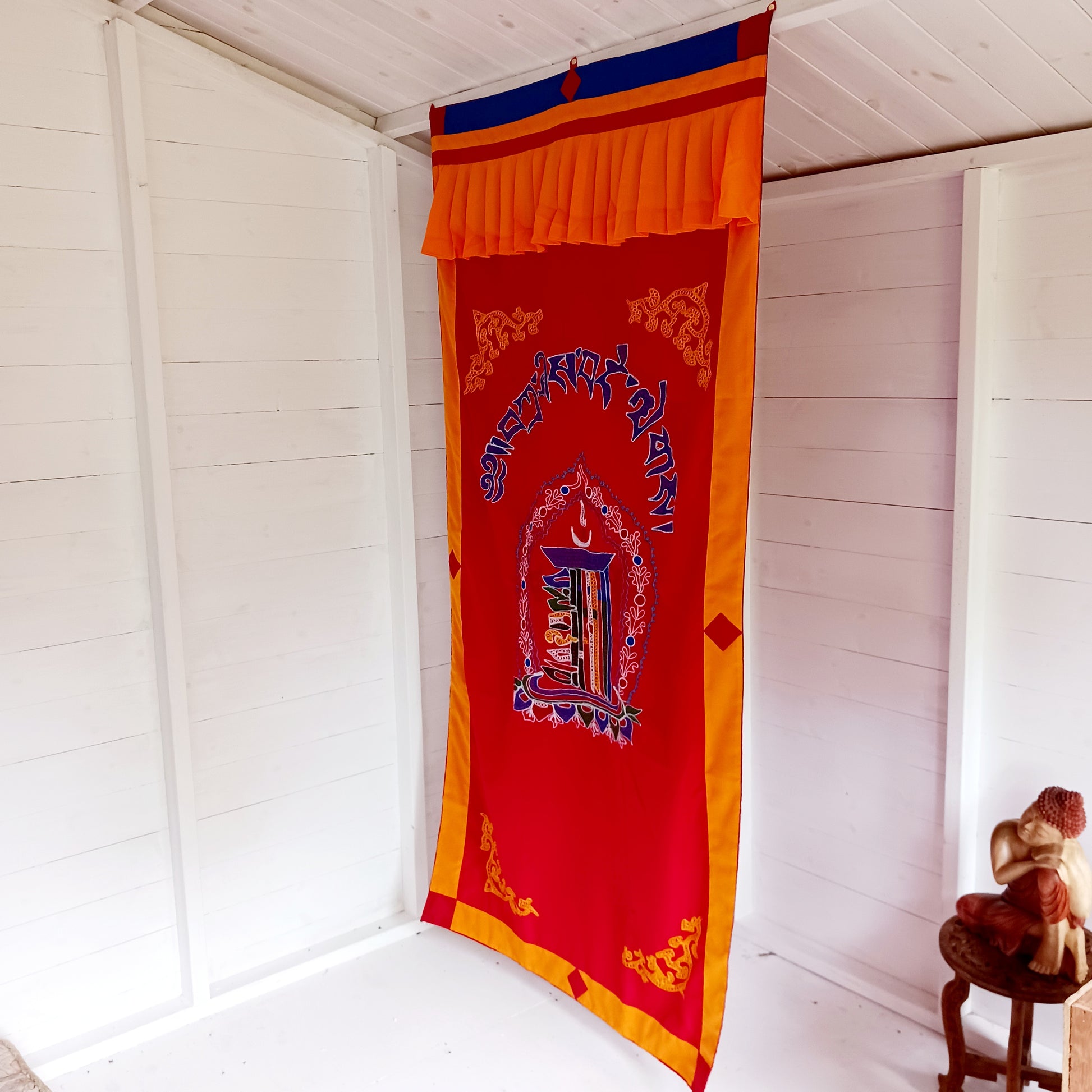 A fine quality traditional Tibetan door curtain displaying a hand embroidered Kalachakra. 