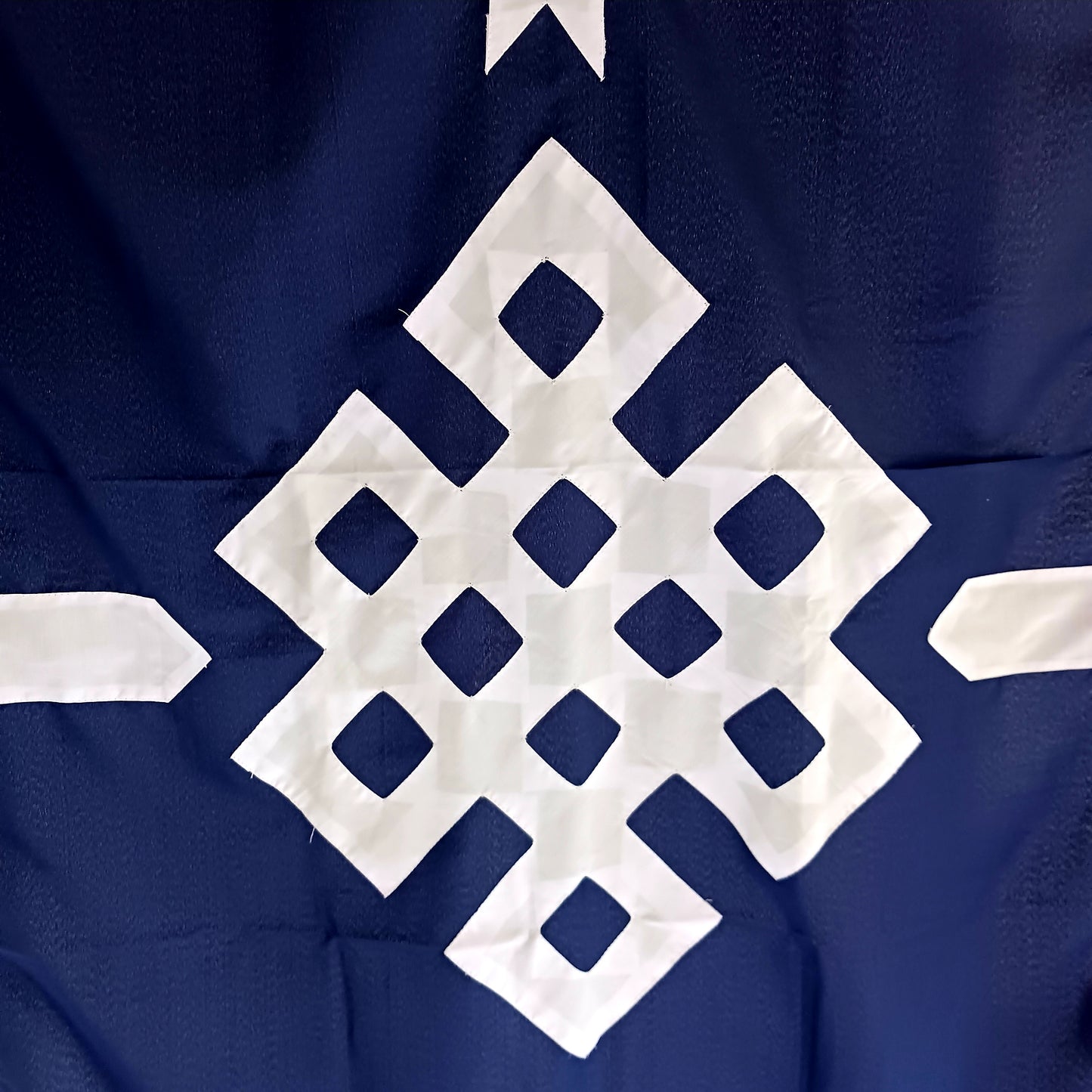 This is a beautifully patched Endless Knot on blue cotton Tibetan Buddhist door curtain.