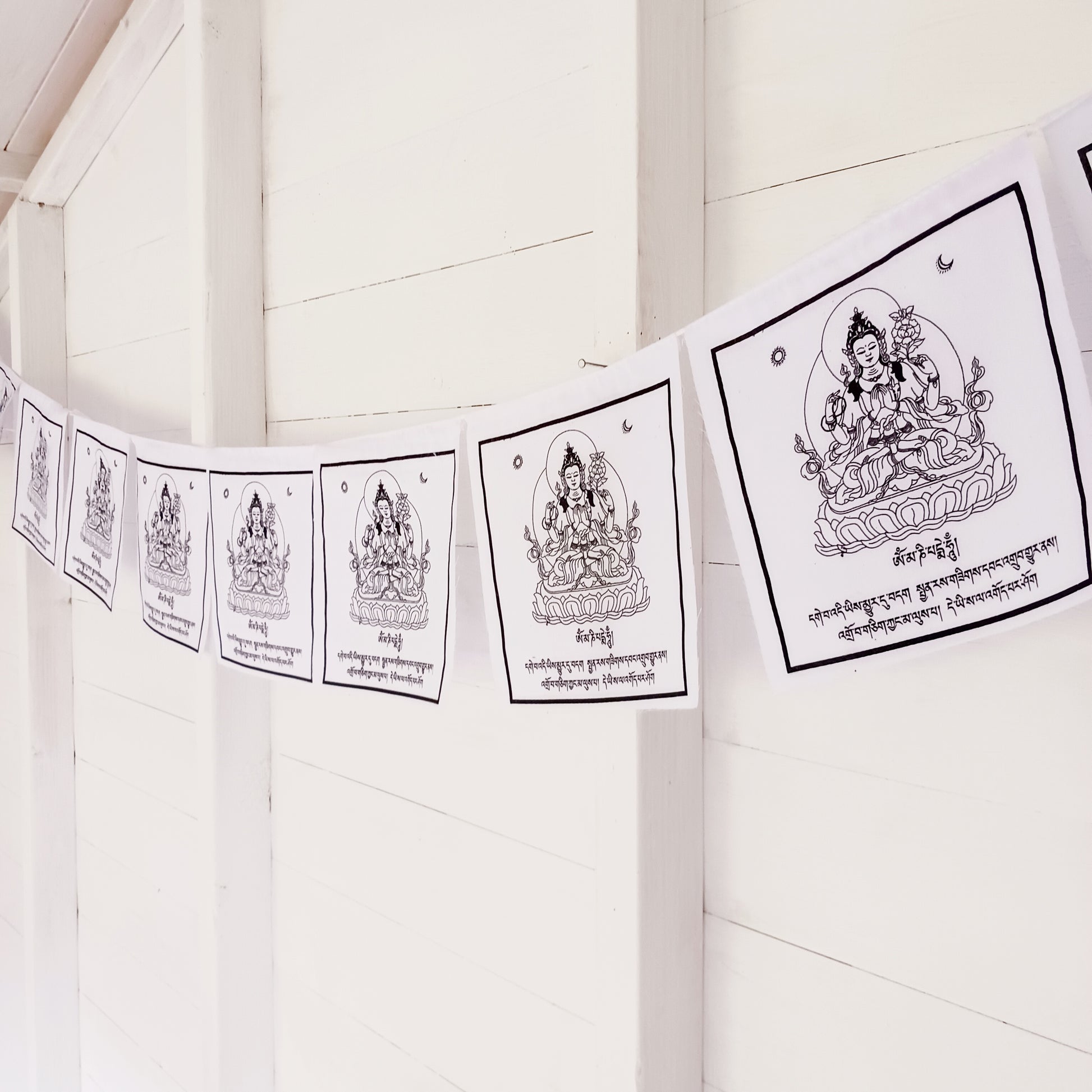 Experience the tranquil and compassionate energy of Chenrezig solid white Tibetan Prayer Flags. 