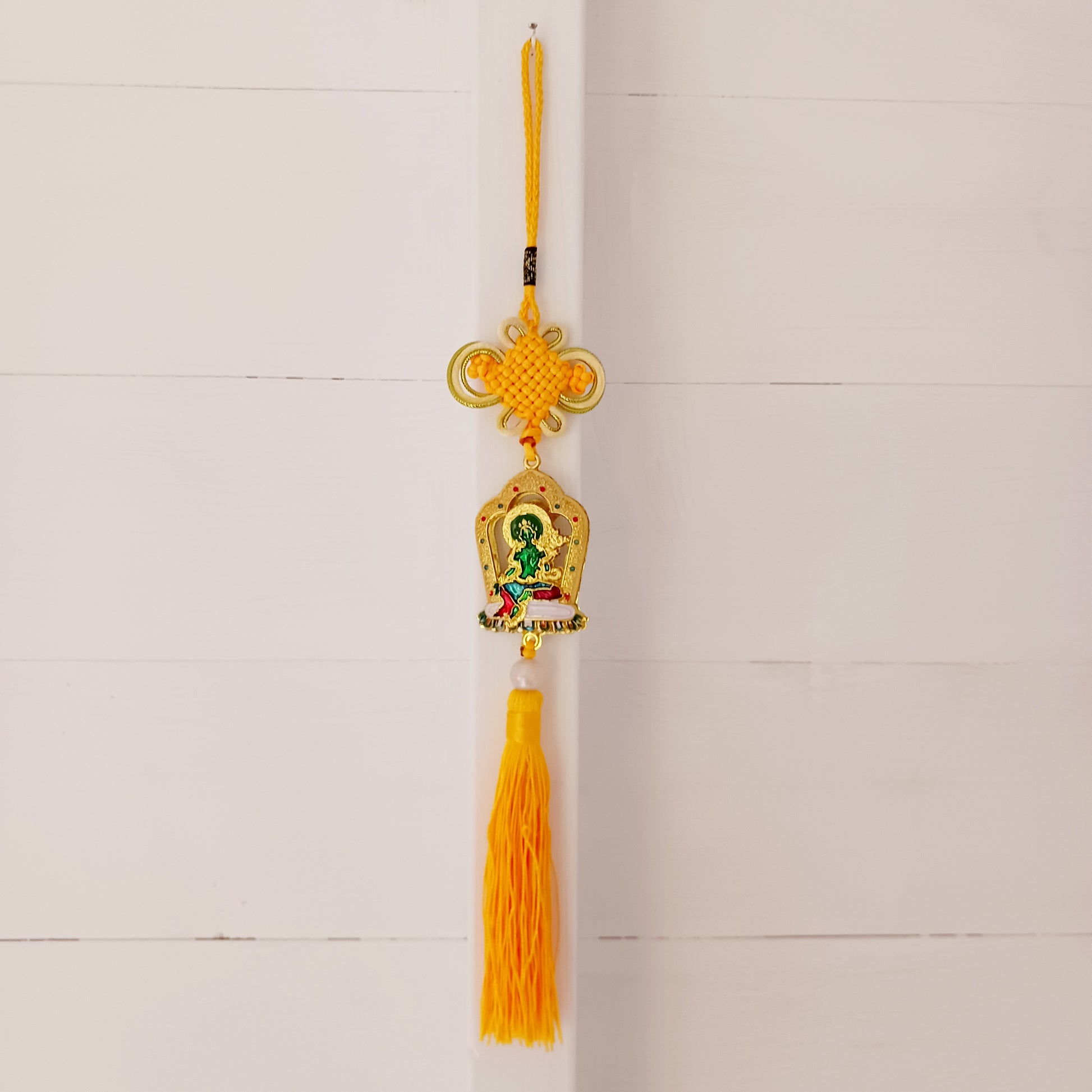 This beautifully decorated Green Tara Tibetan Buddhist amulet can be used as a wall hanging or car hanging decoration.