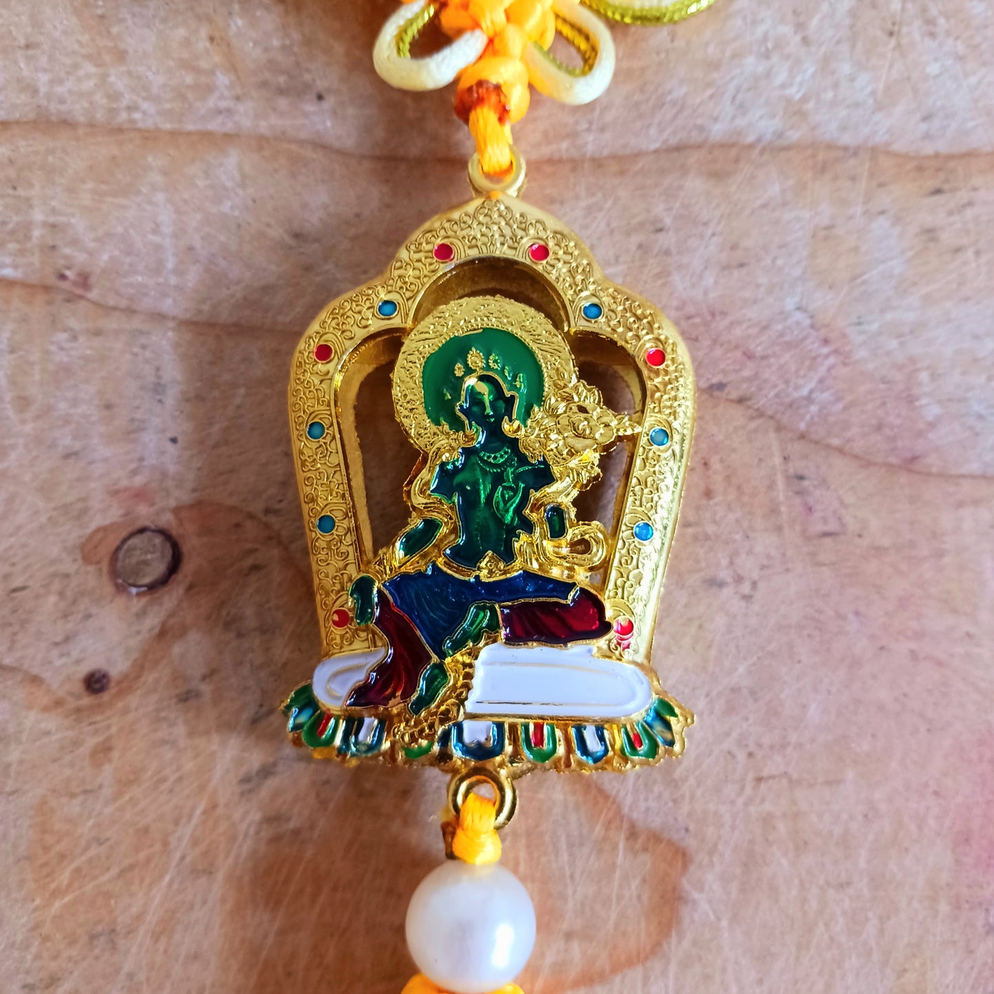 This beautifully decorated Green Tara Tibetan Buddhist amulet can be used as a wall hanging or car hanging decoration.