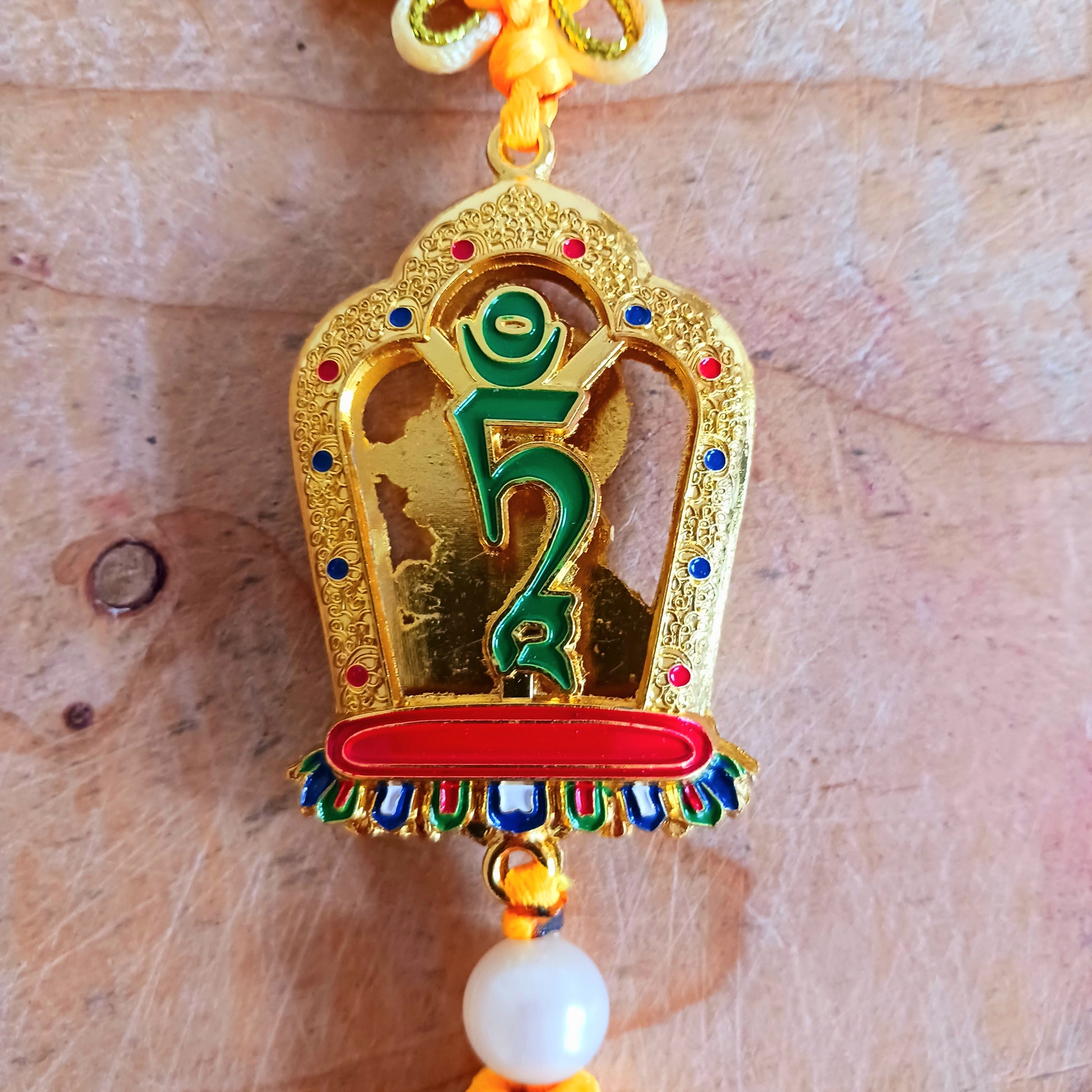 This beautifully decorated Green Tara Tibetan Buddhist amulet can be used as a wall hanging or car hanging decoration.