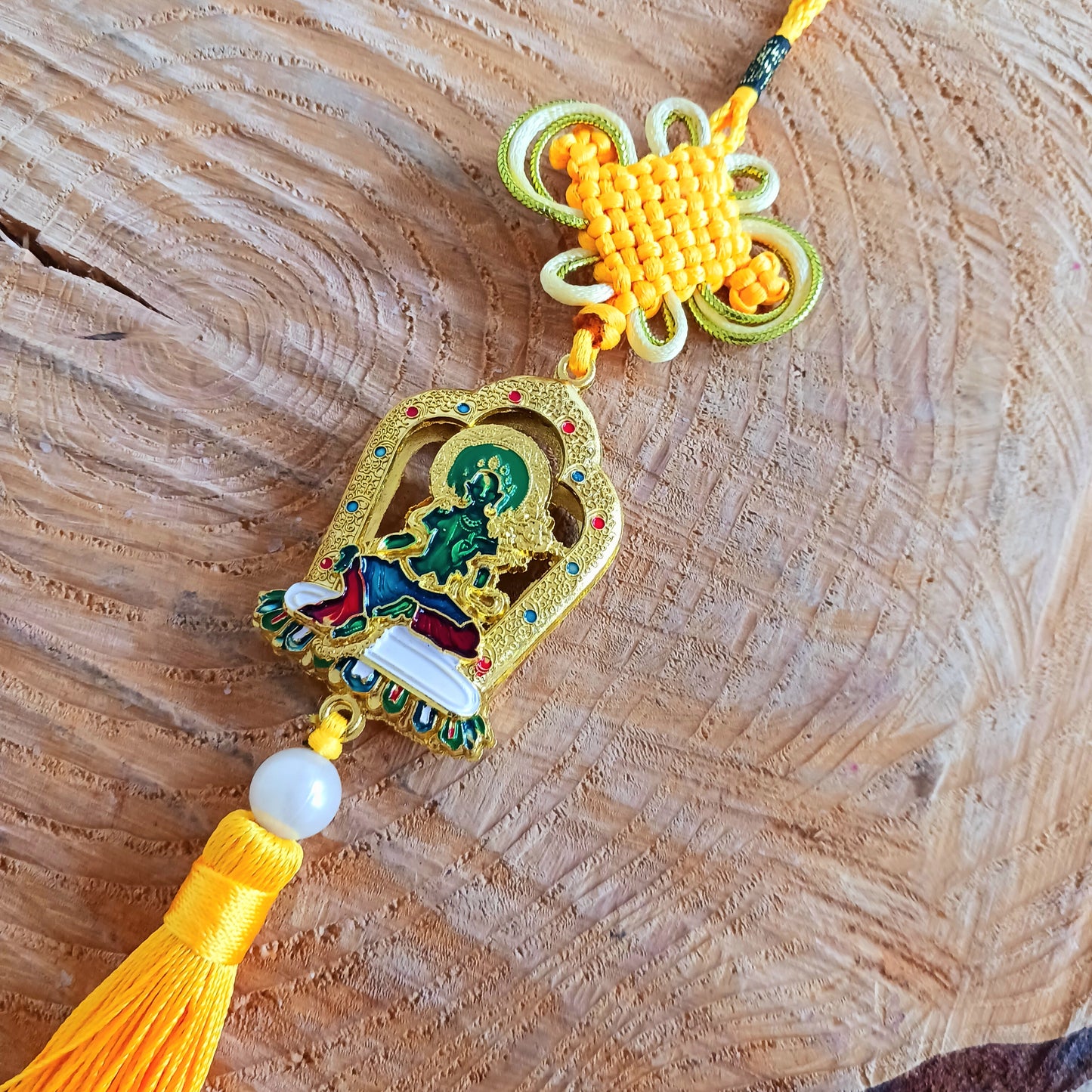 This beautifully decorated Green Tara Tibetan Buddhist amulet can be used as a wall hanging or car hanging decoration.