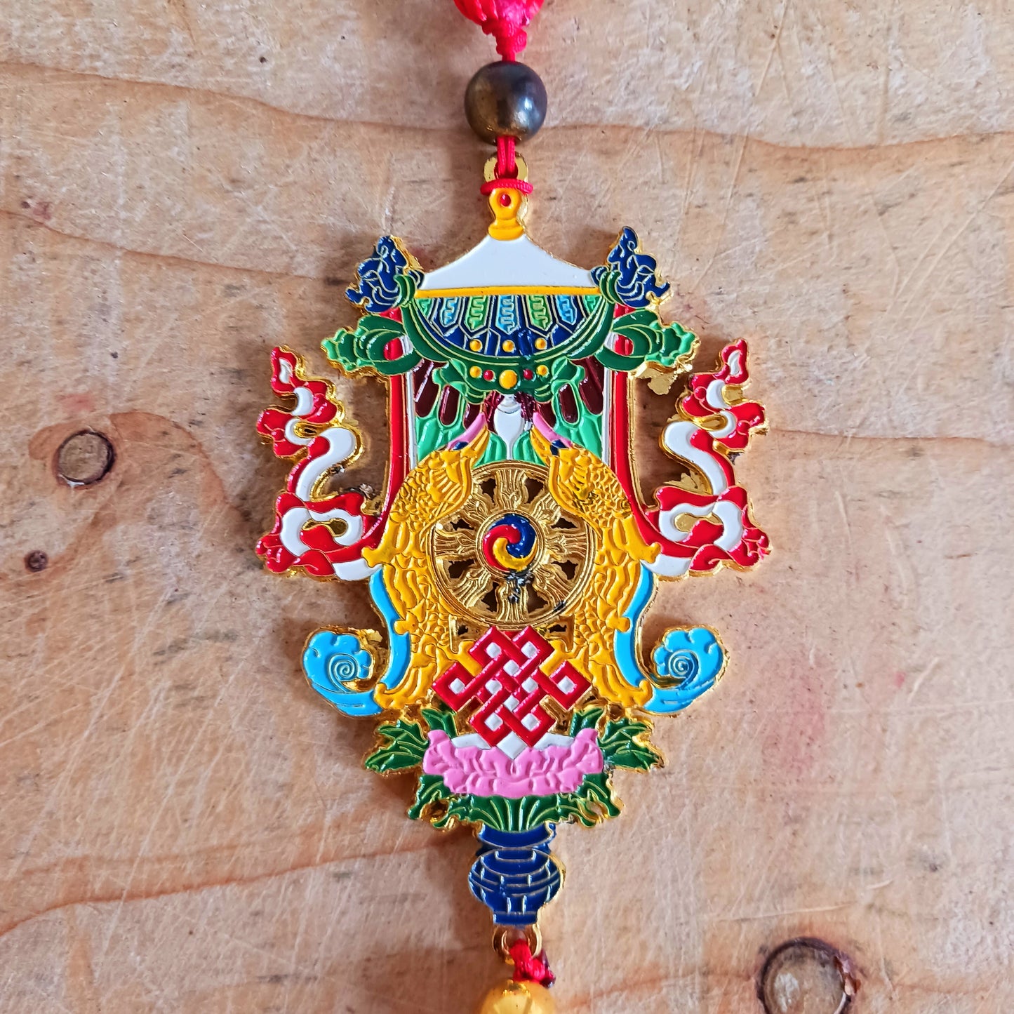 This beautifully decorated Auspicious Symbols Tibetan Buddhist amulet can be used as a wall hanging or car hanging decoration.