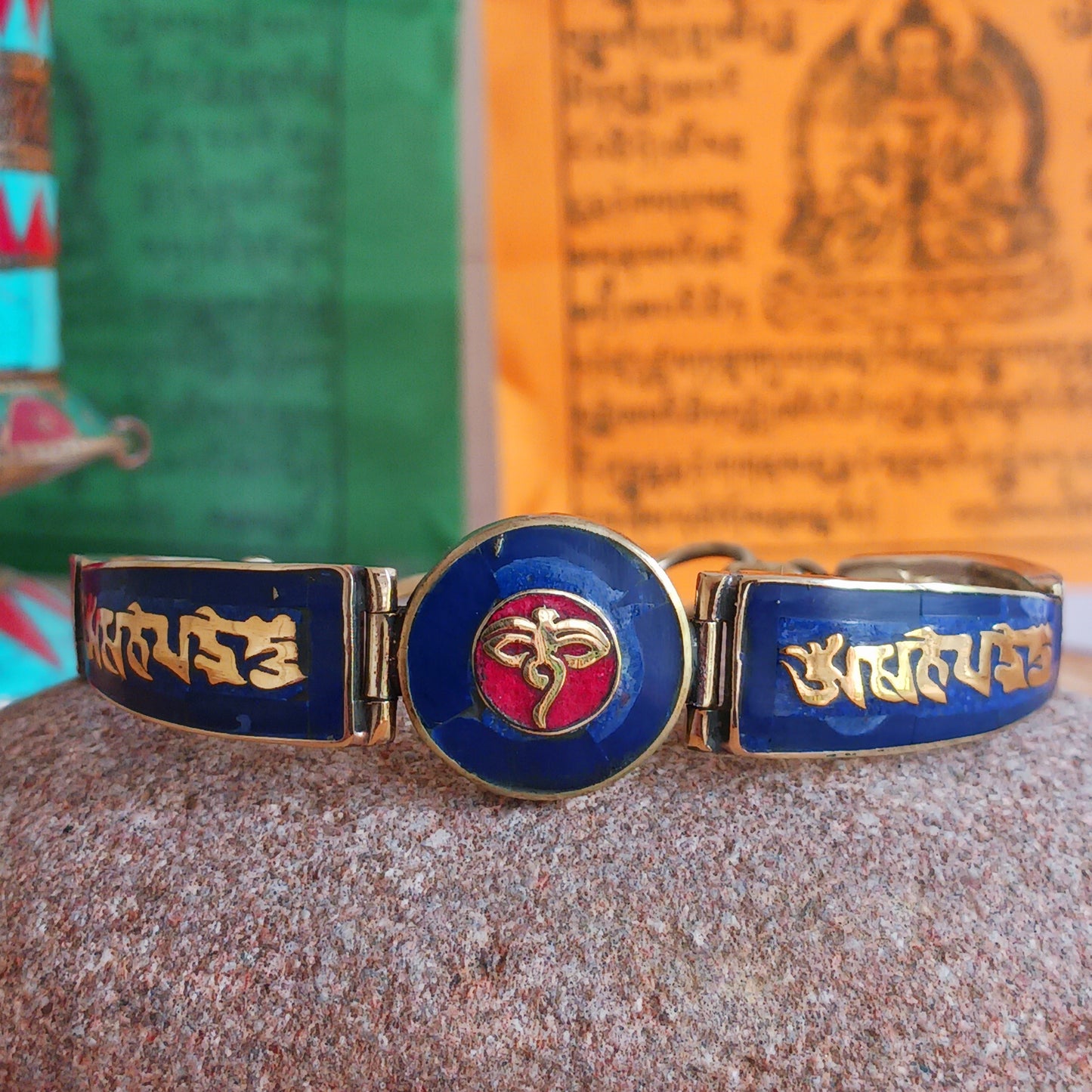 This Tibetan Mantra bracelets are made from brass with inlaid lapis and coral chips.