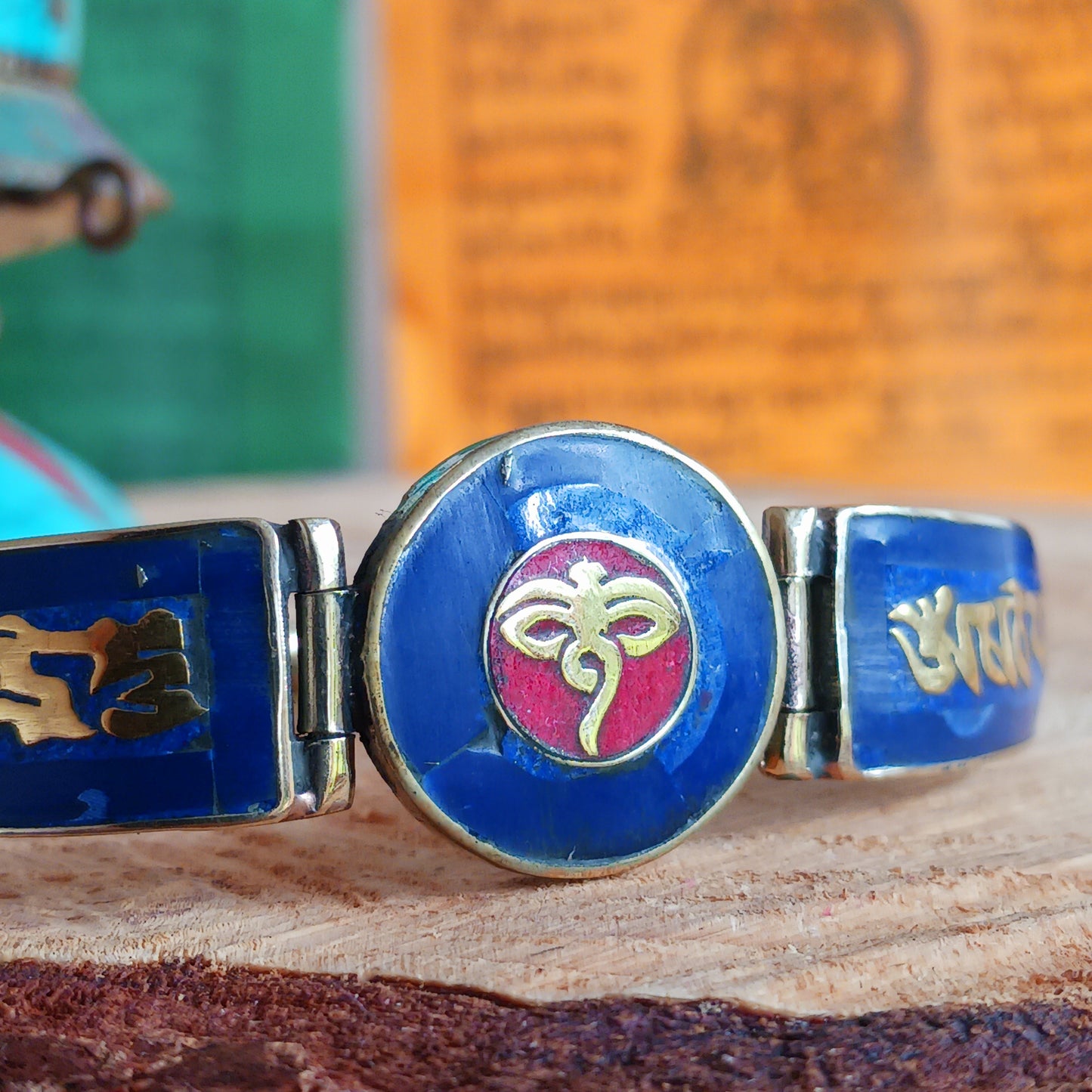 This Tibetan Mantra bracelets are made from brass with inlaid lapis and coral chips.