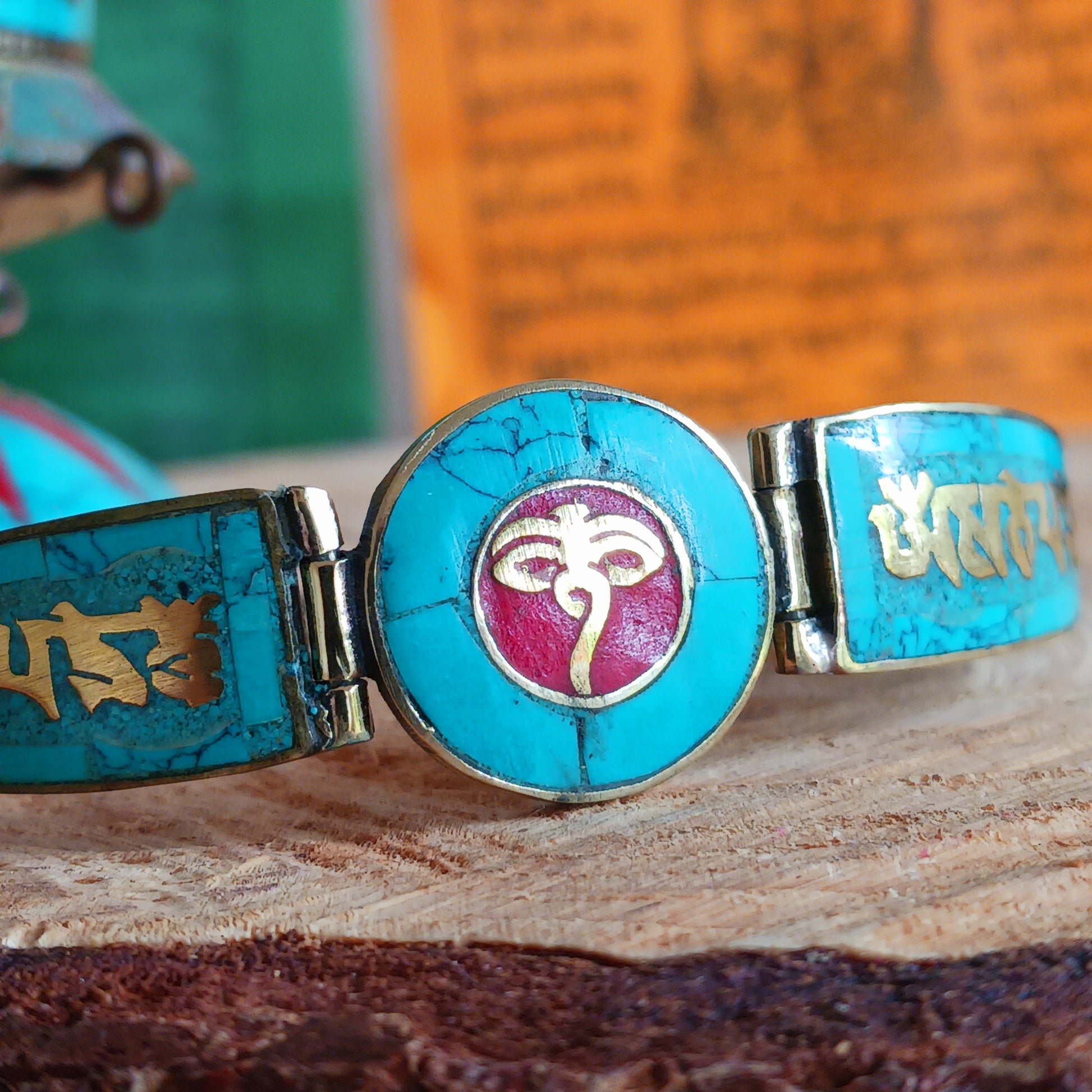 This Tibetan Mantra bracelets are made from brass with inlaid turquoise and coral chips.