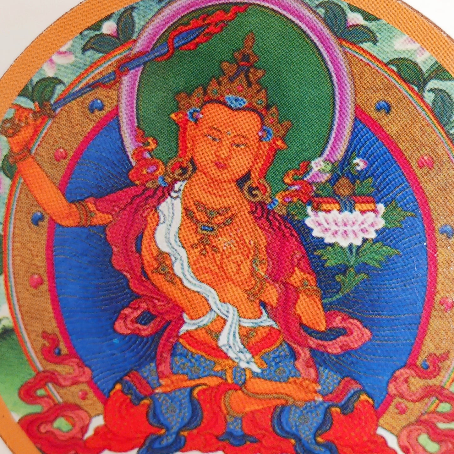  Manjushri is often depicted holding a book in one hand, symbolizing the teachings of Buddha (dharma) and in the other a wisdom sword, to cut through the roots of ignorance.