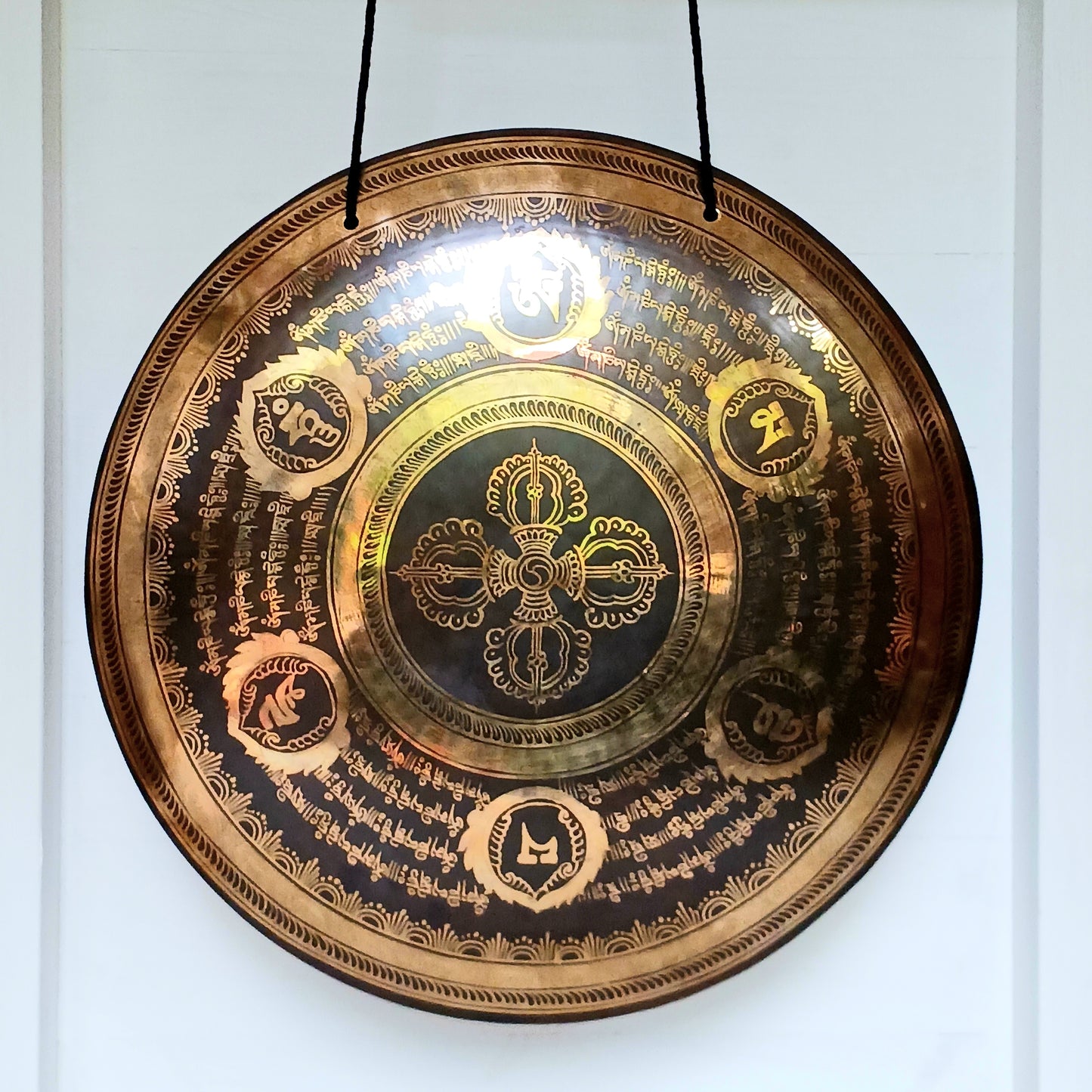 This is a beautiful hand beaten Tibetan Gong, hand-etched with Tibetan Buddhist Mantra, designs and motifs, including a Double Dorje in the centre.